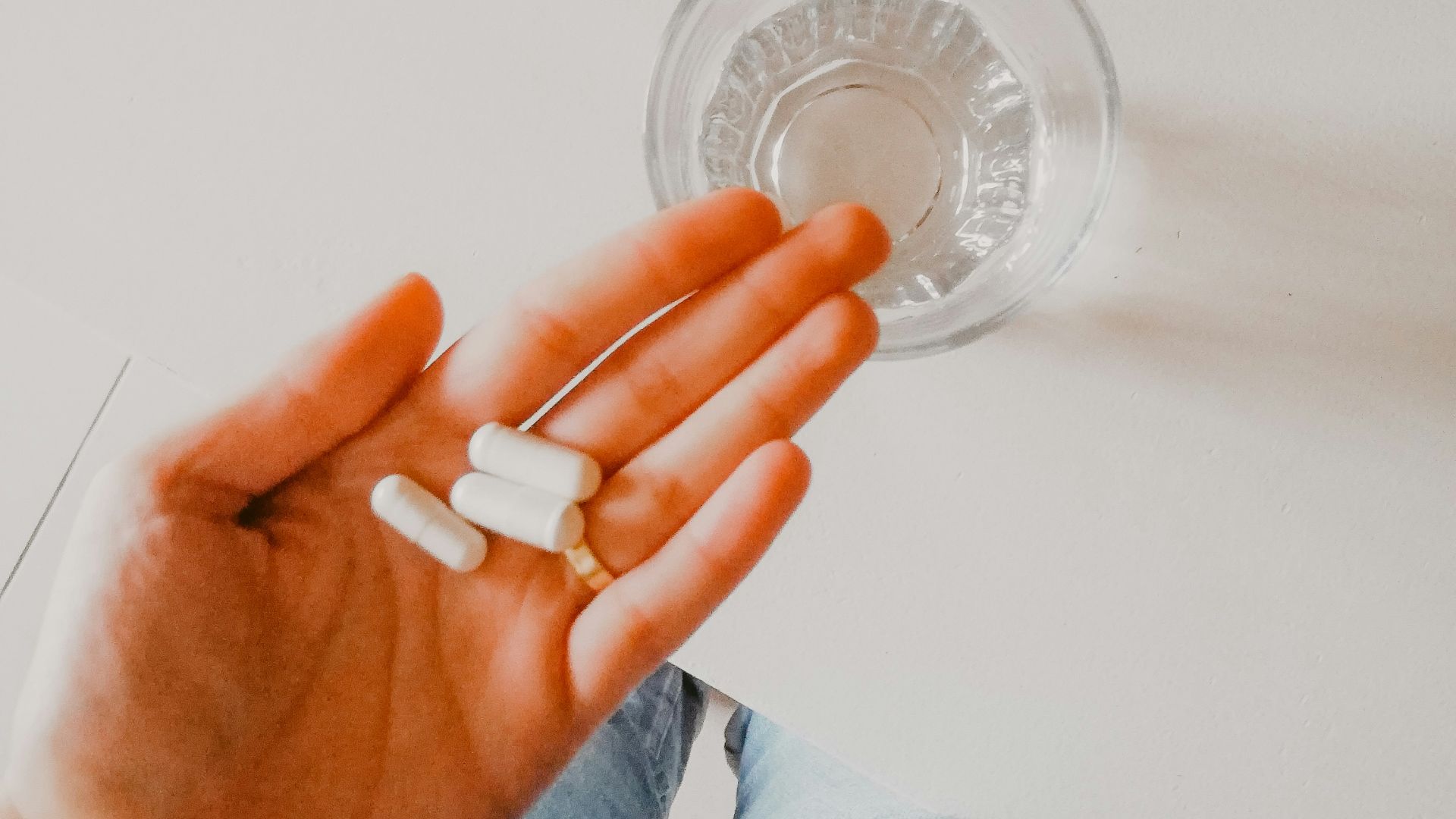 person holding white medication pill