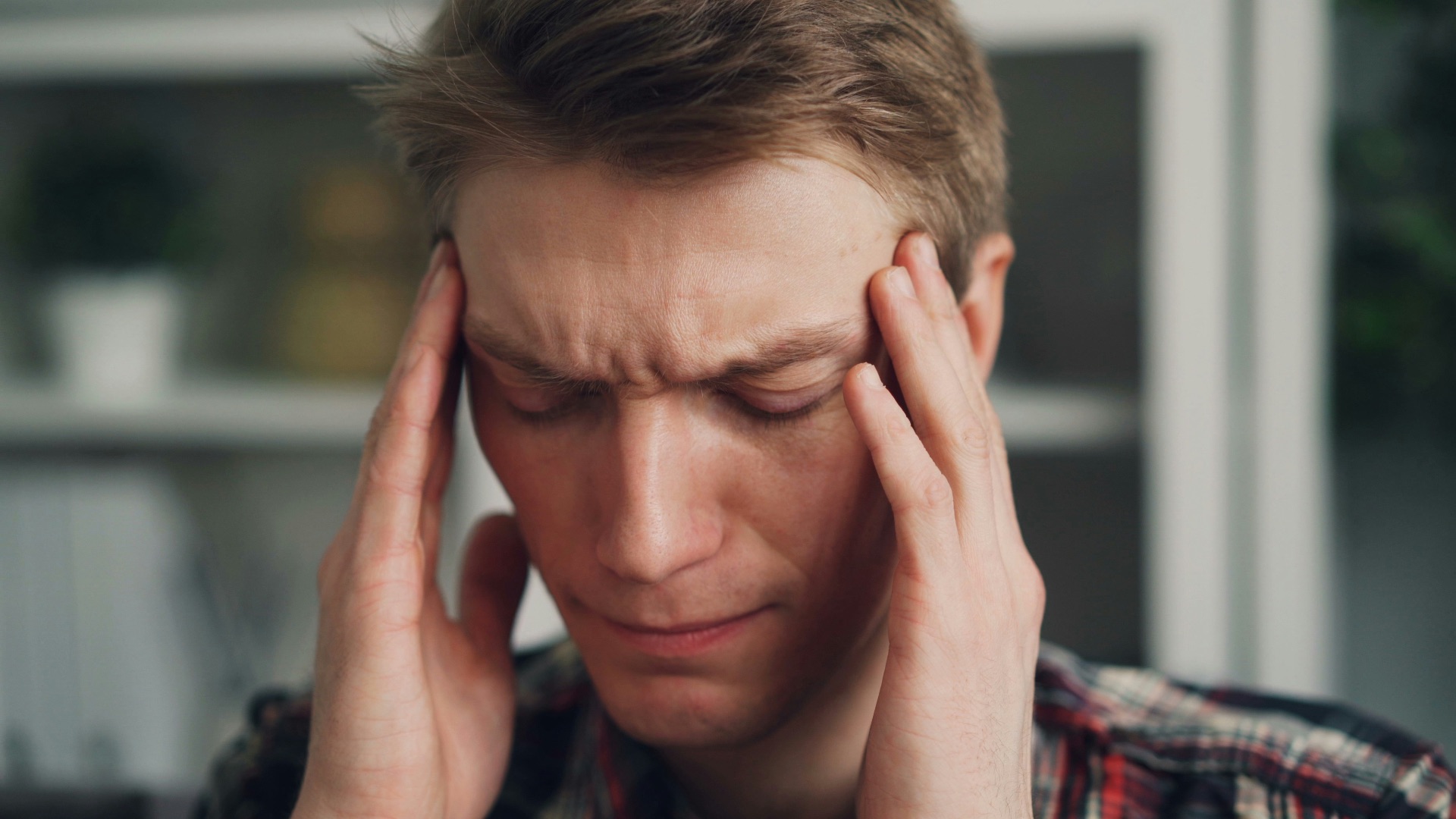 a man holding his hands to his ears
