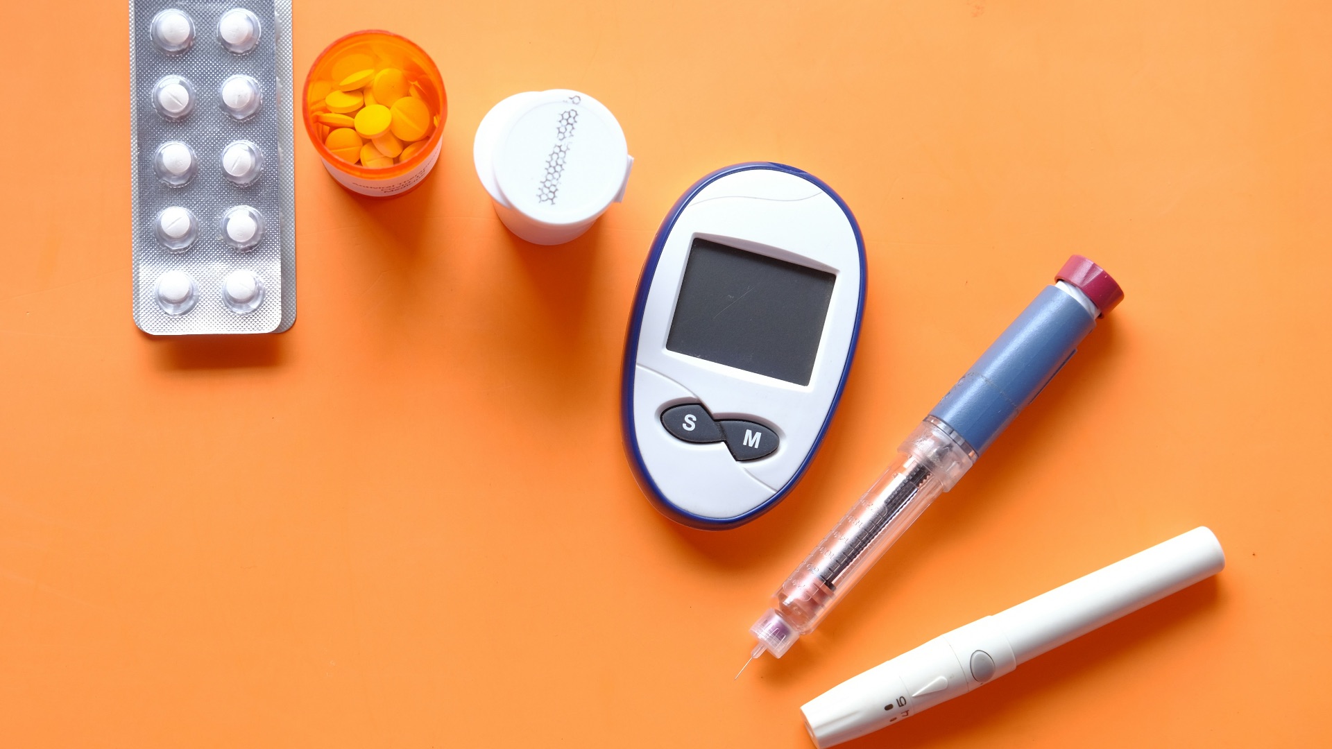 white digital device beside white pen