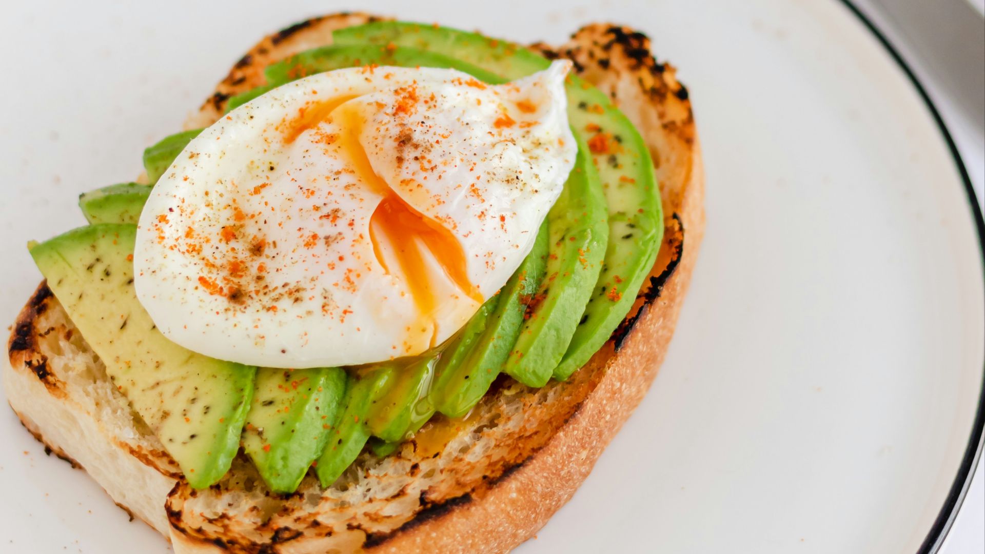 a sandwich with an egg and asparagus on it