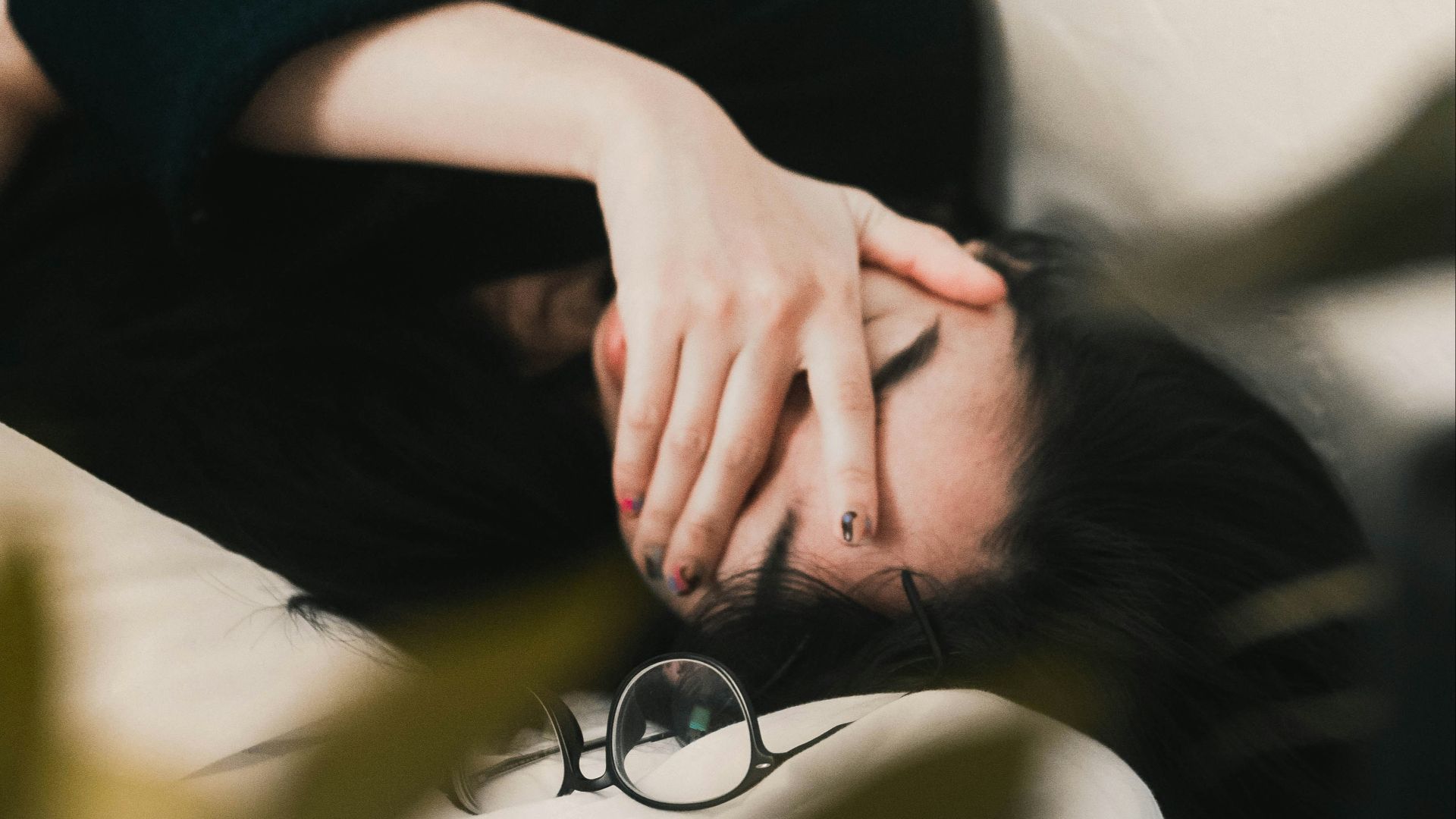 woman in black long sleeve shirt covering her face