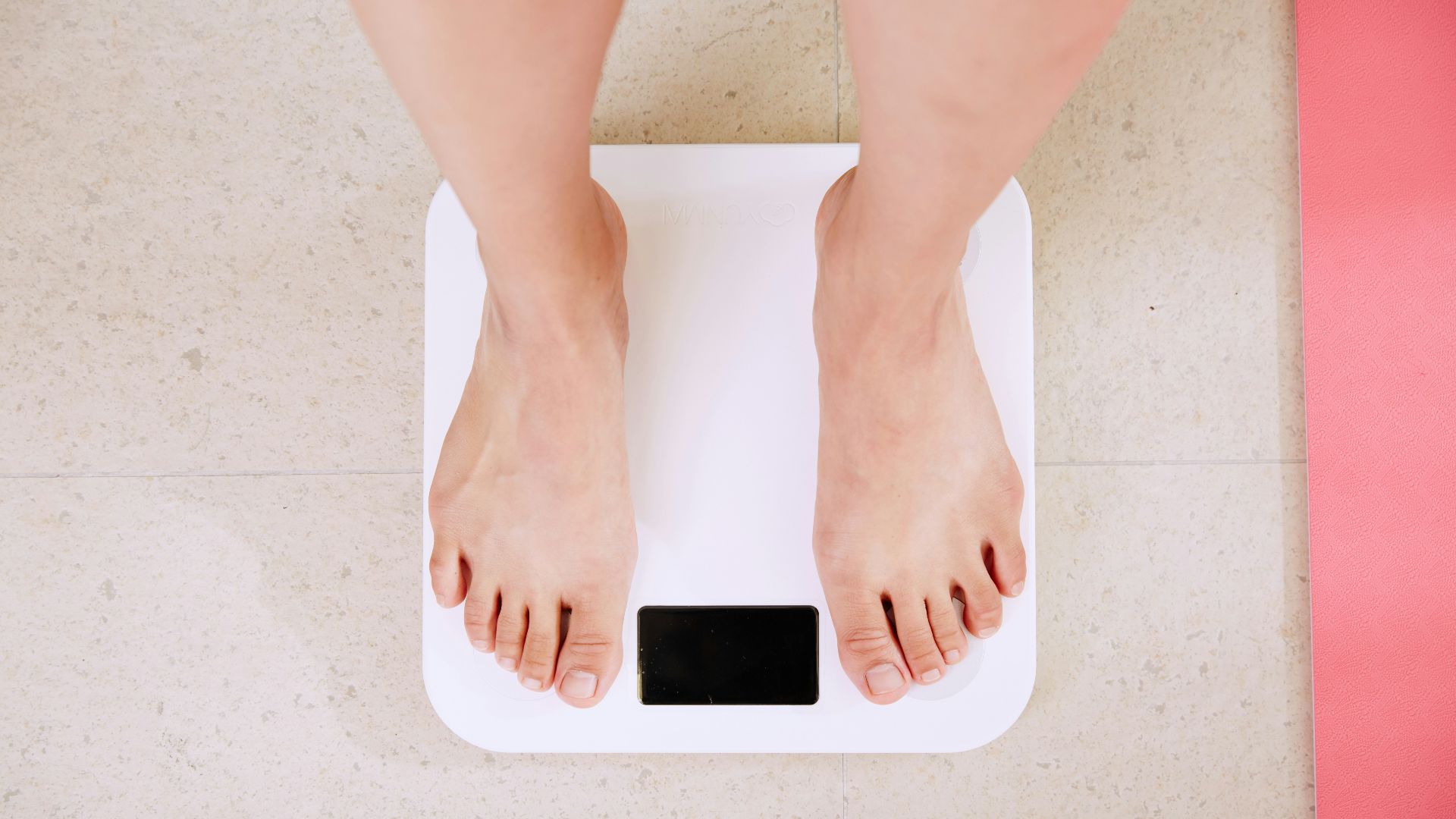 person standing on white digital bathroom scale
