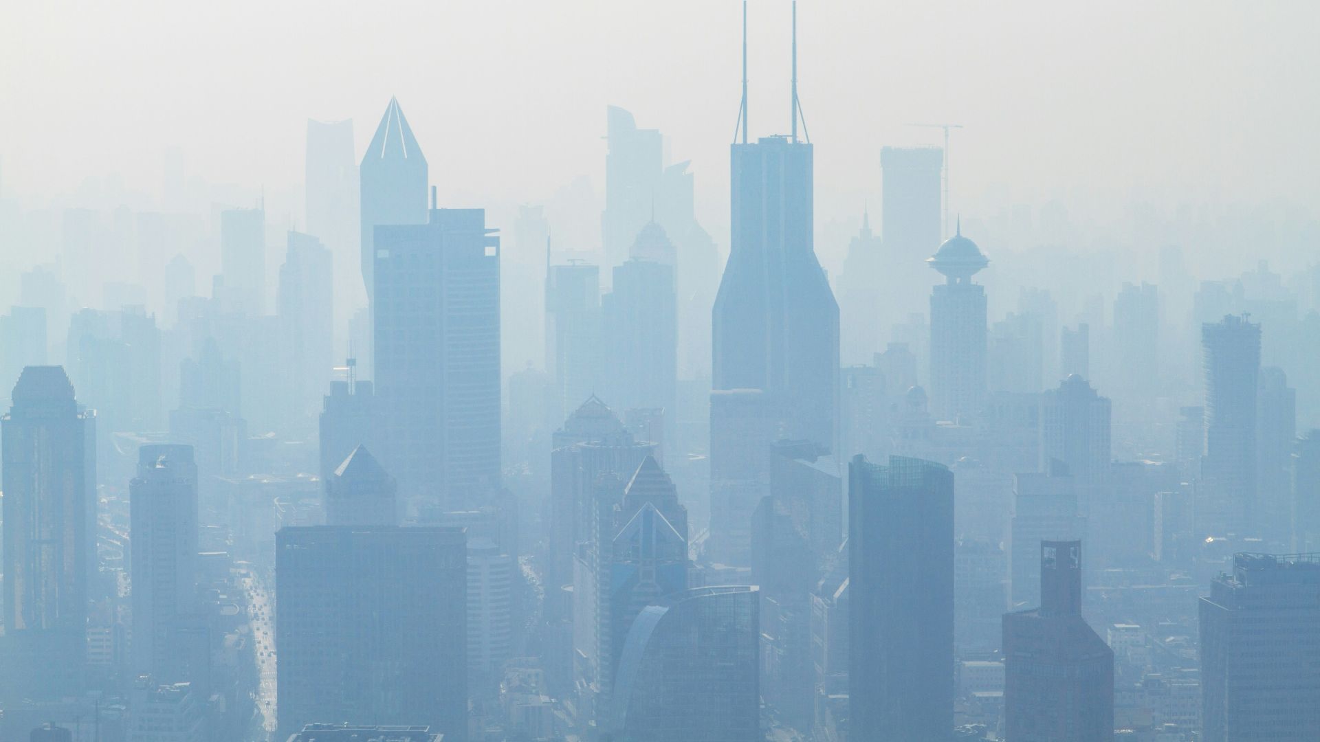 aerial view of high-rise buildings covered with smoke