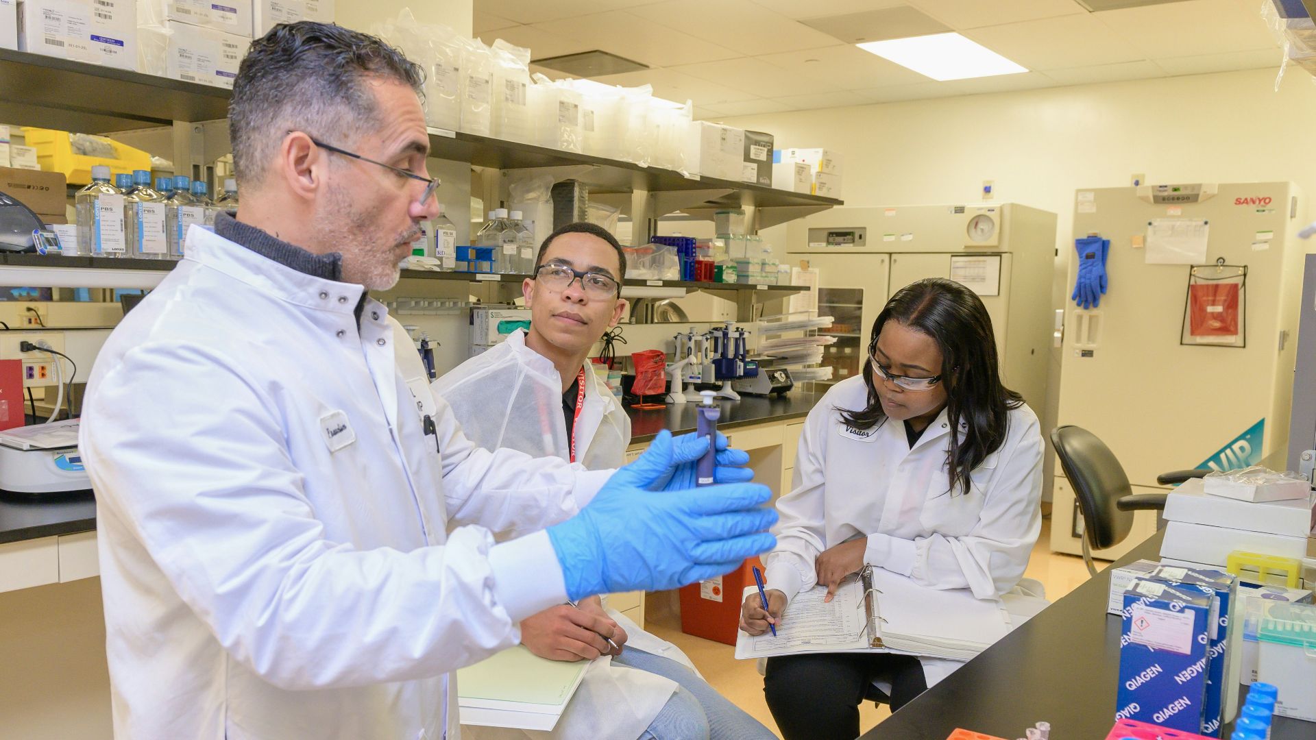 a group of people in a lab looking at something