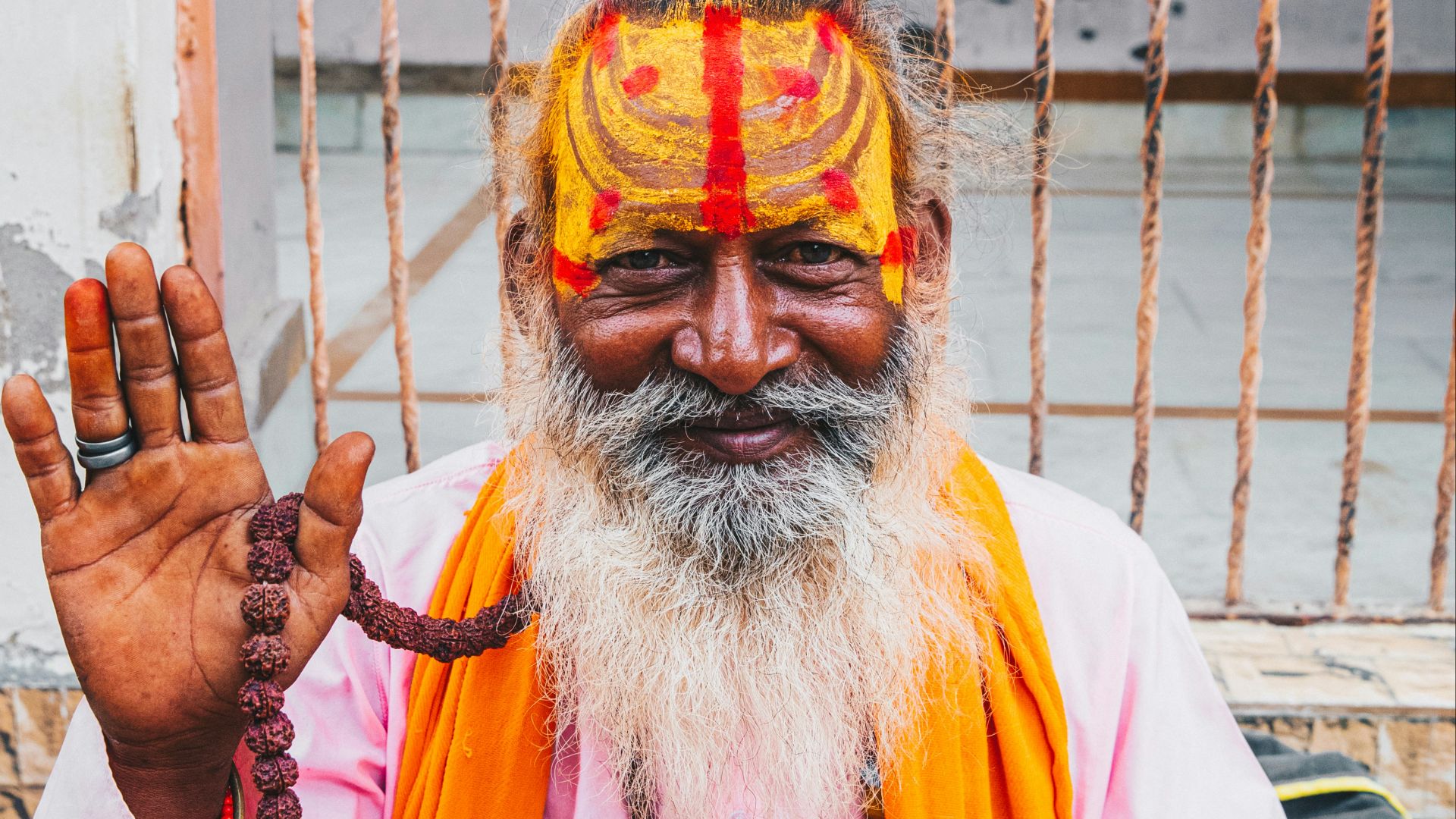 man in white long sleeve shirt with yellow and red face paint