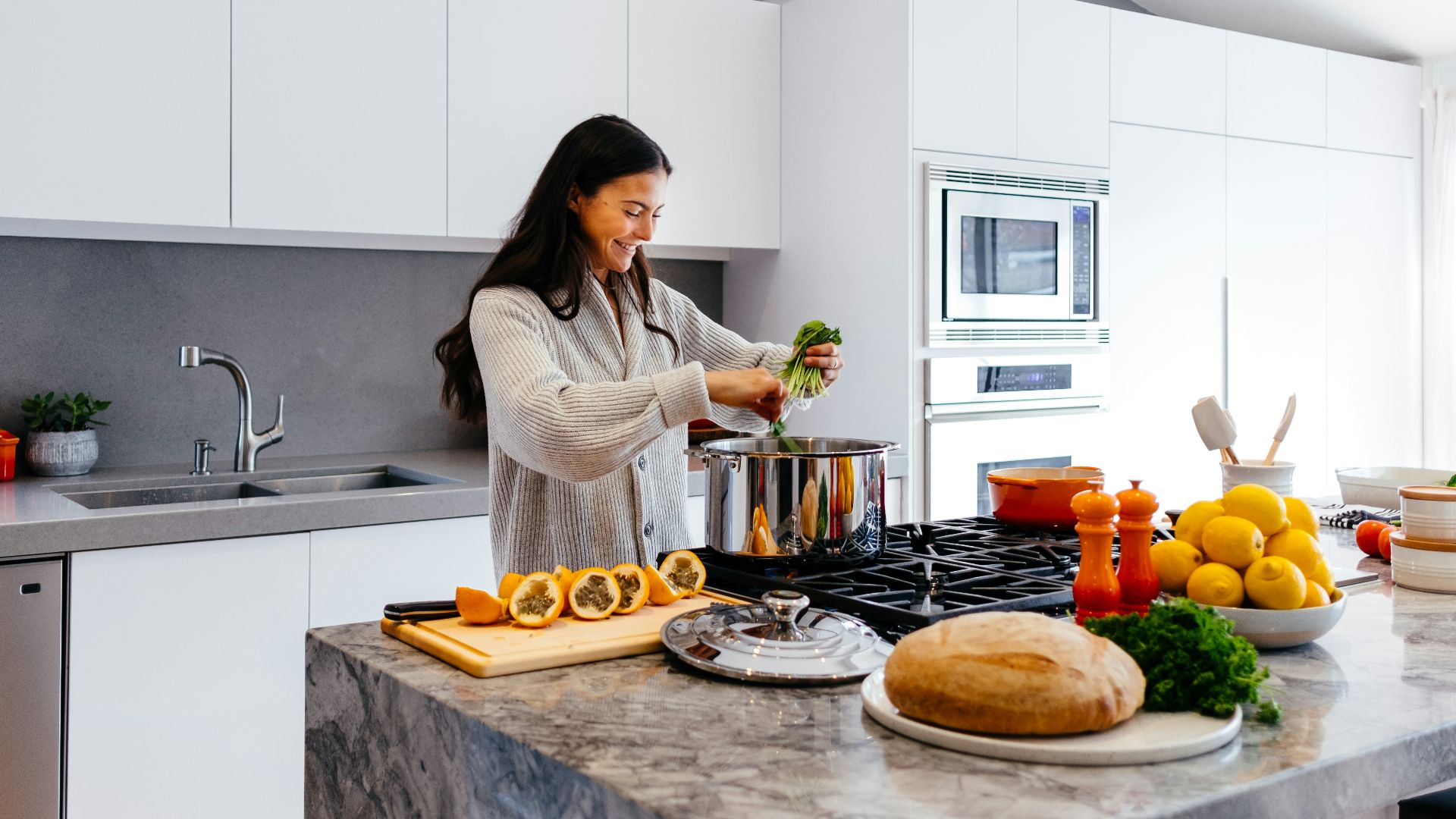 woman smiling while cooking