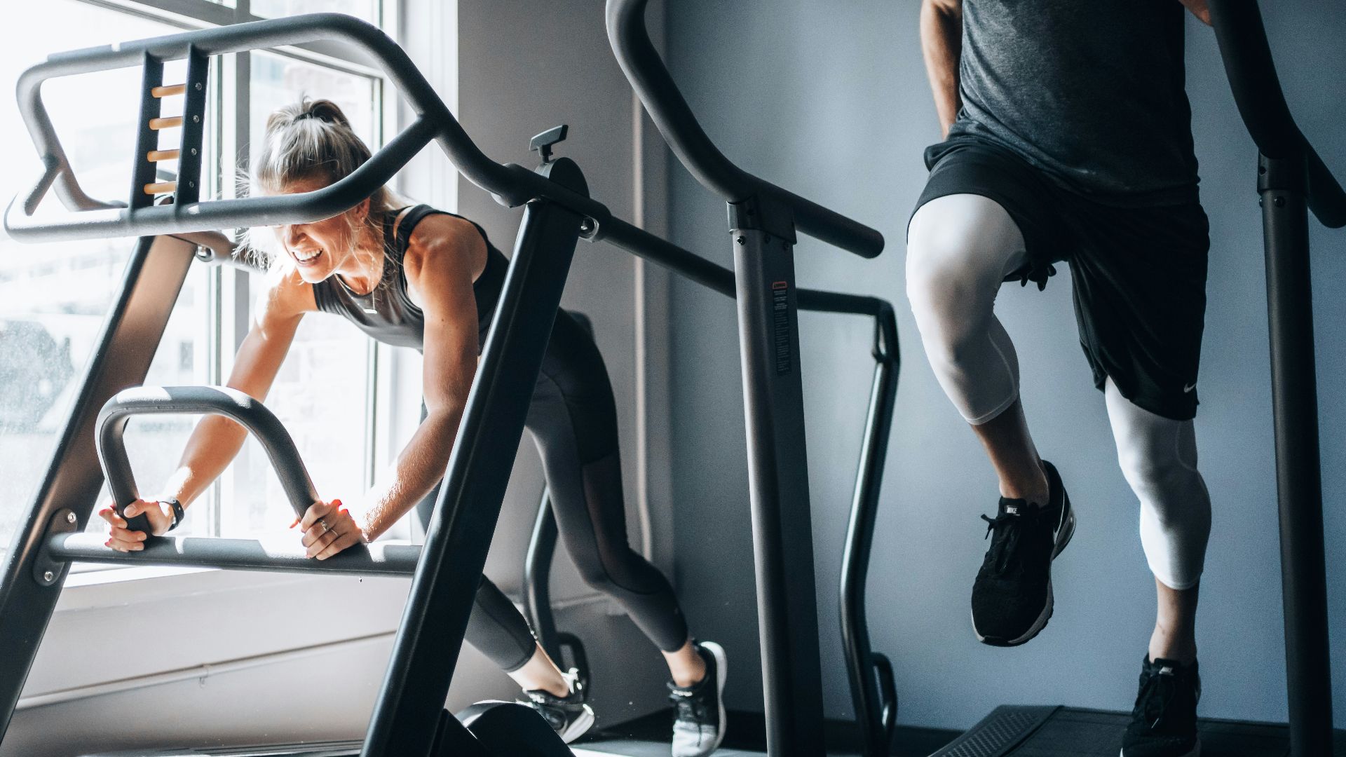 woman in black tank top and black shorts sitting on black exercise equipment