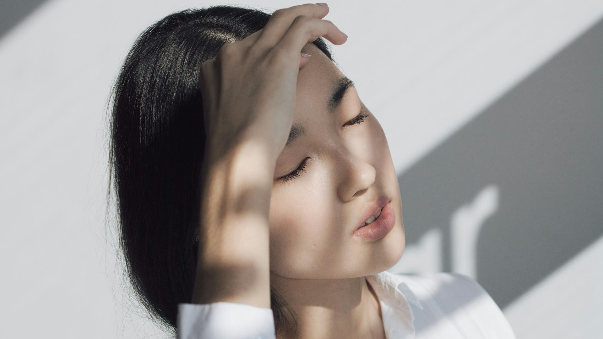 woman leaning on white table