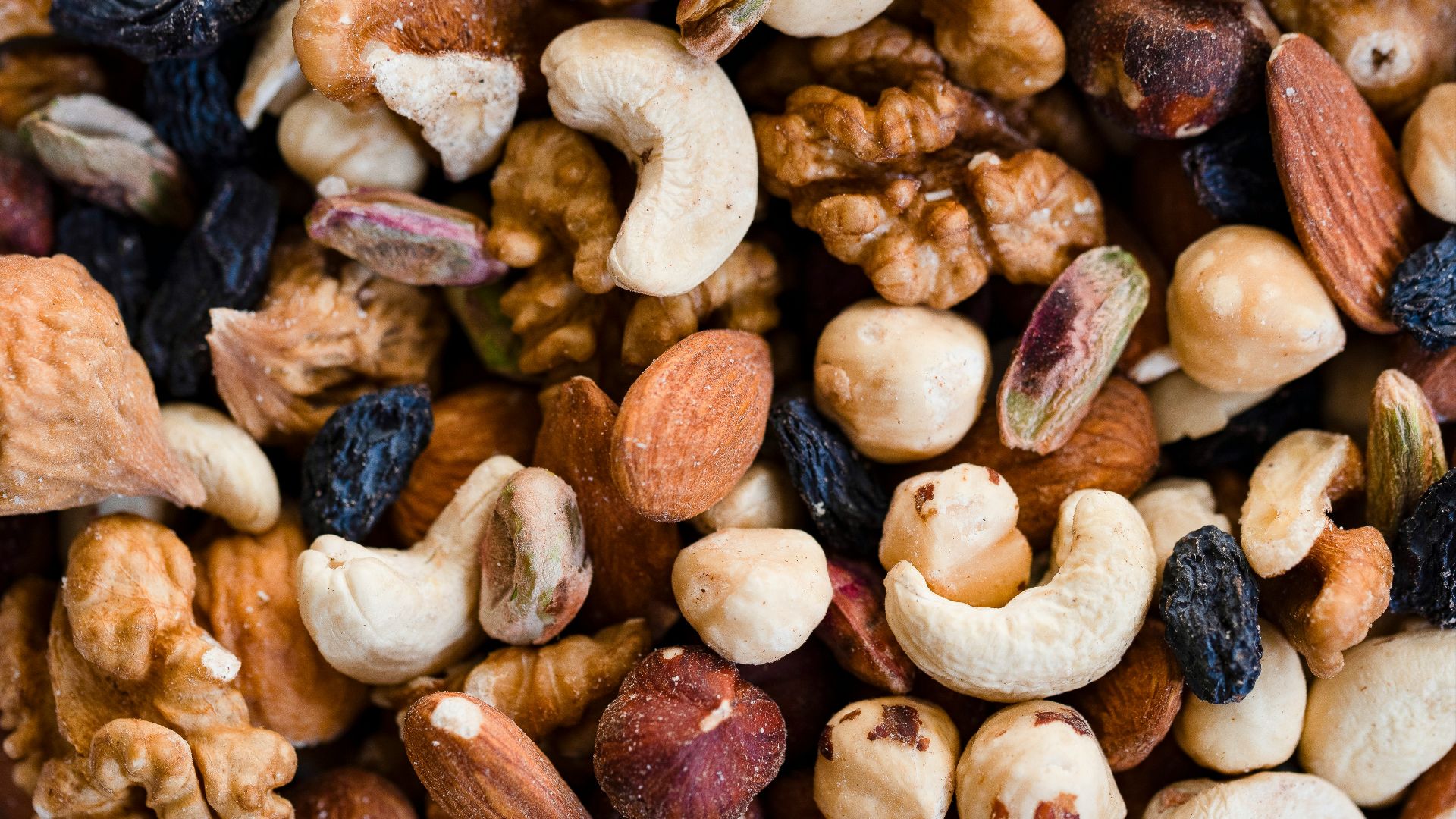 A close-up view of a mixed nut and raisin blend.