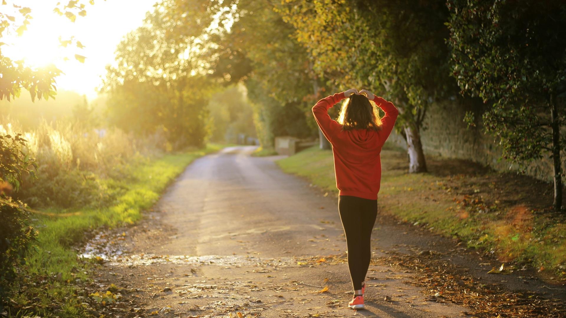 woman walking on pathway during daytime