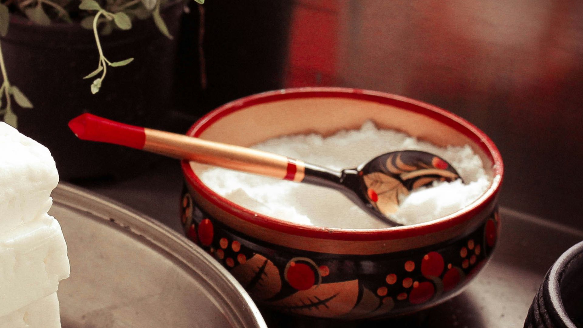 red ceramic bowl on gray spoon