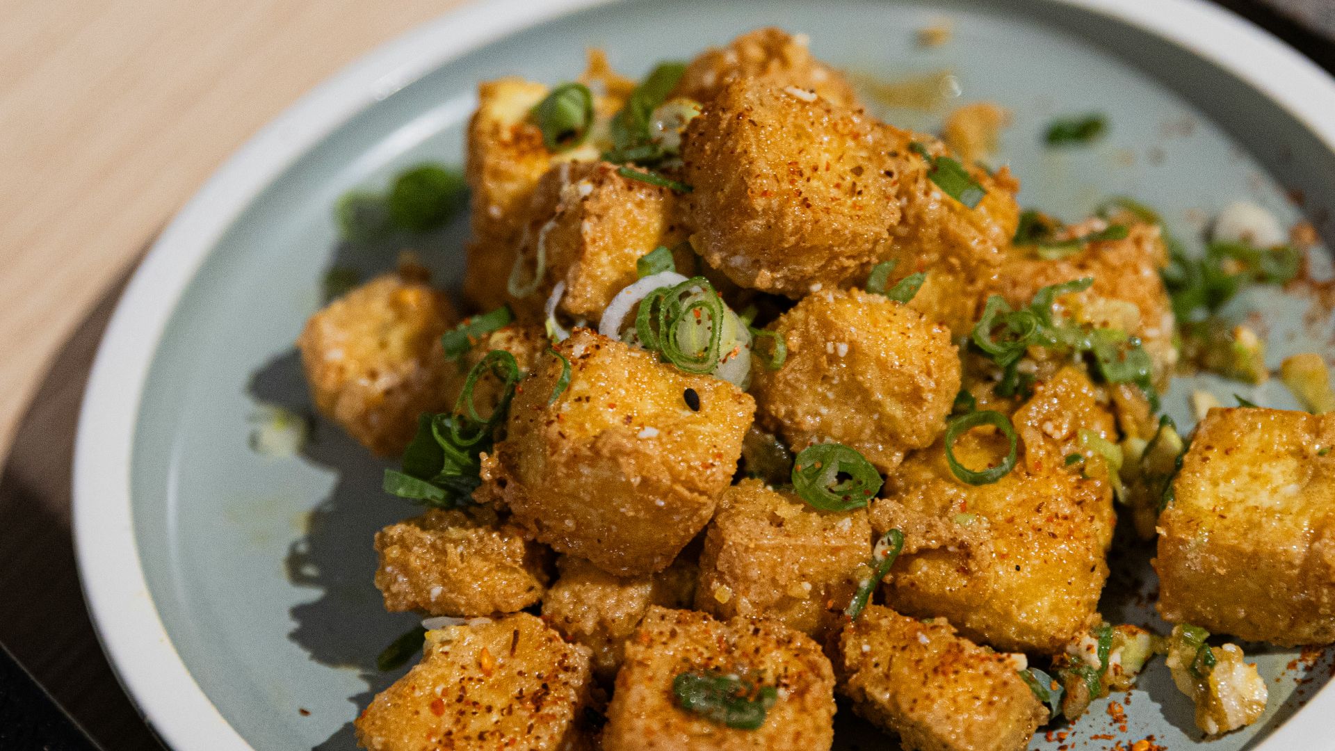 Crispy fried tofu cubes sprinkled with green onions