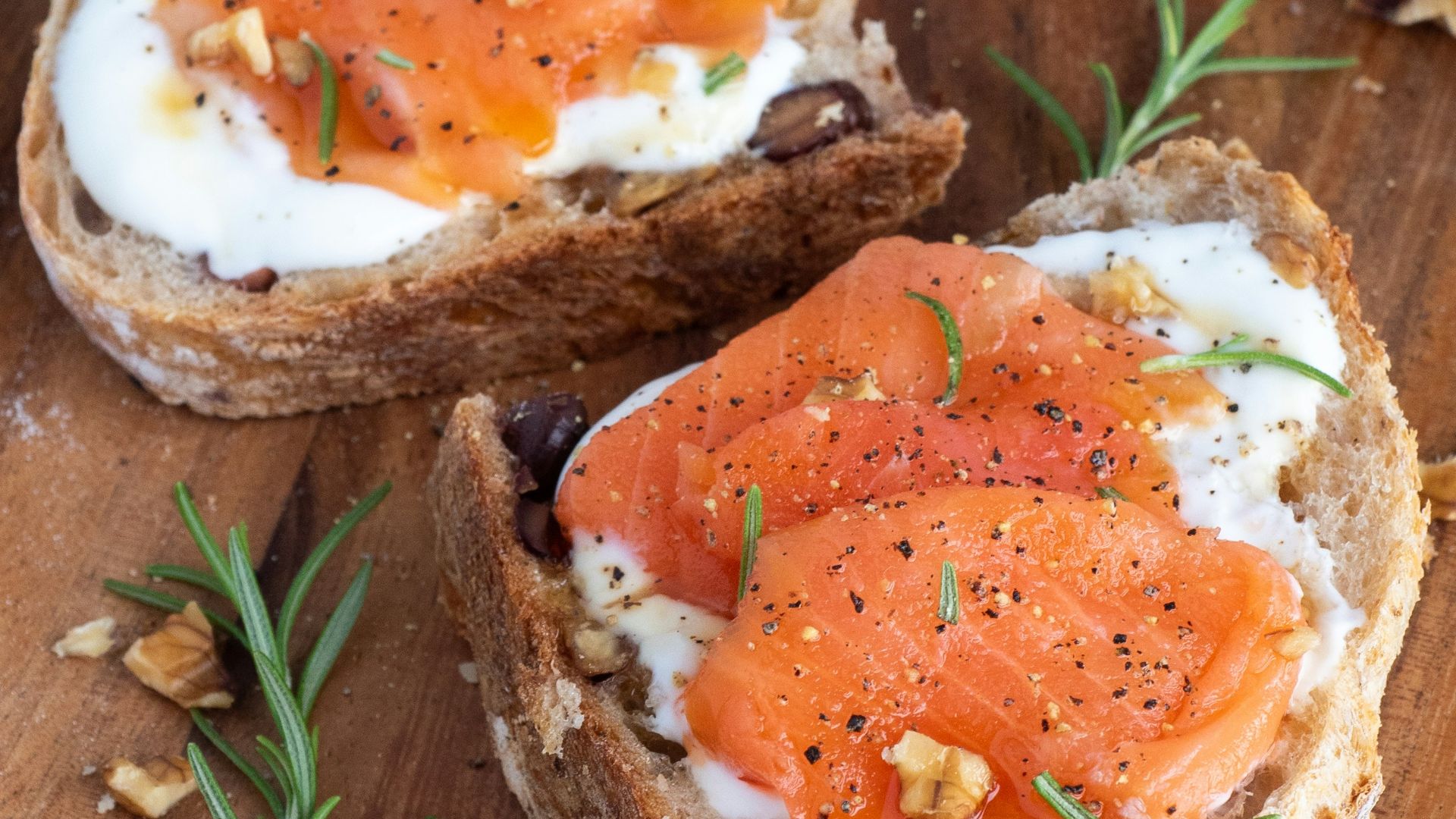 sliced bread with sliced tomato on brown wooden chopping board