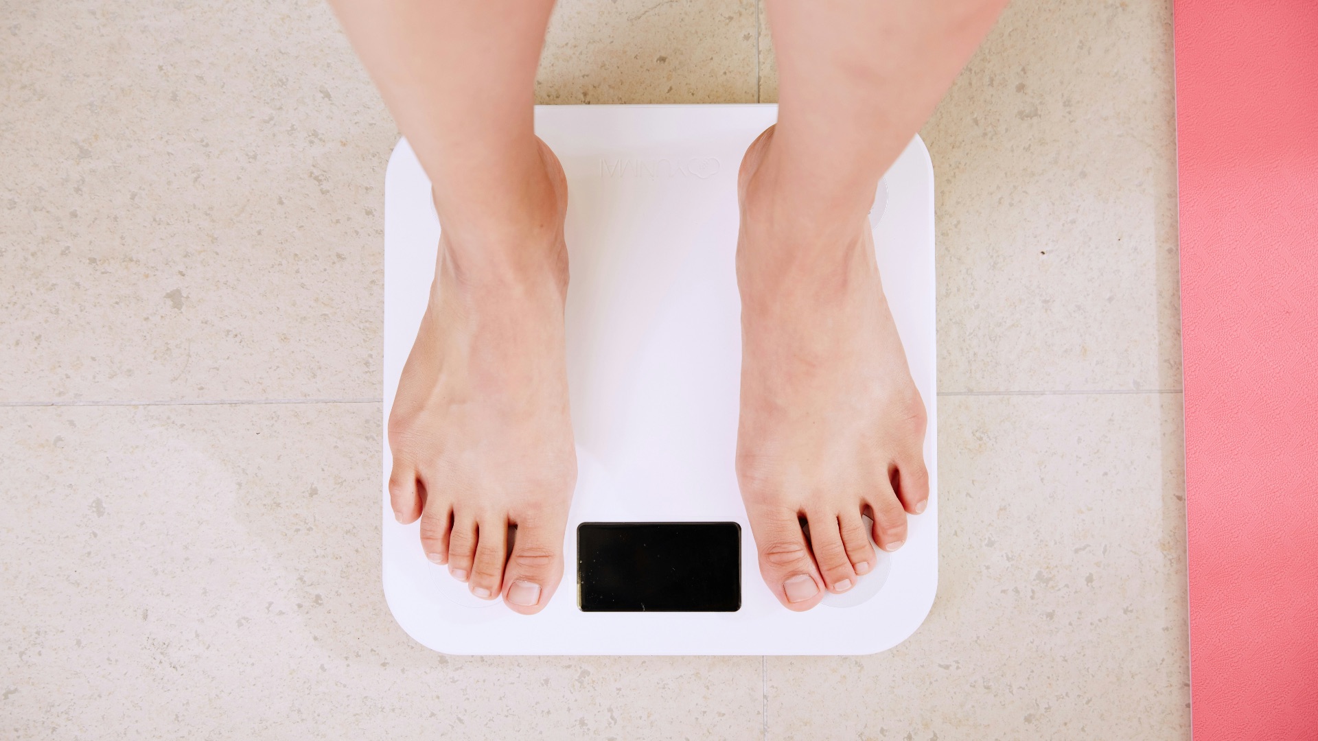person standing on white digital bathroom scale