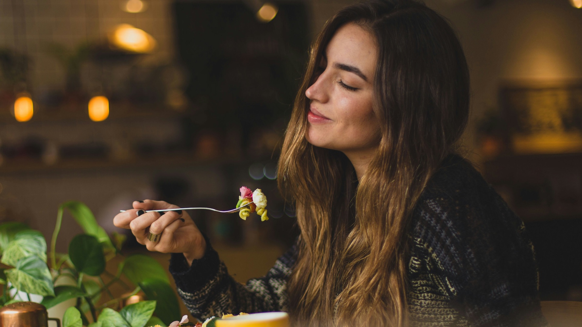 woman holding fork in front table
