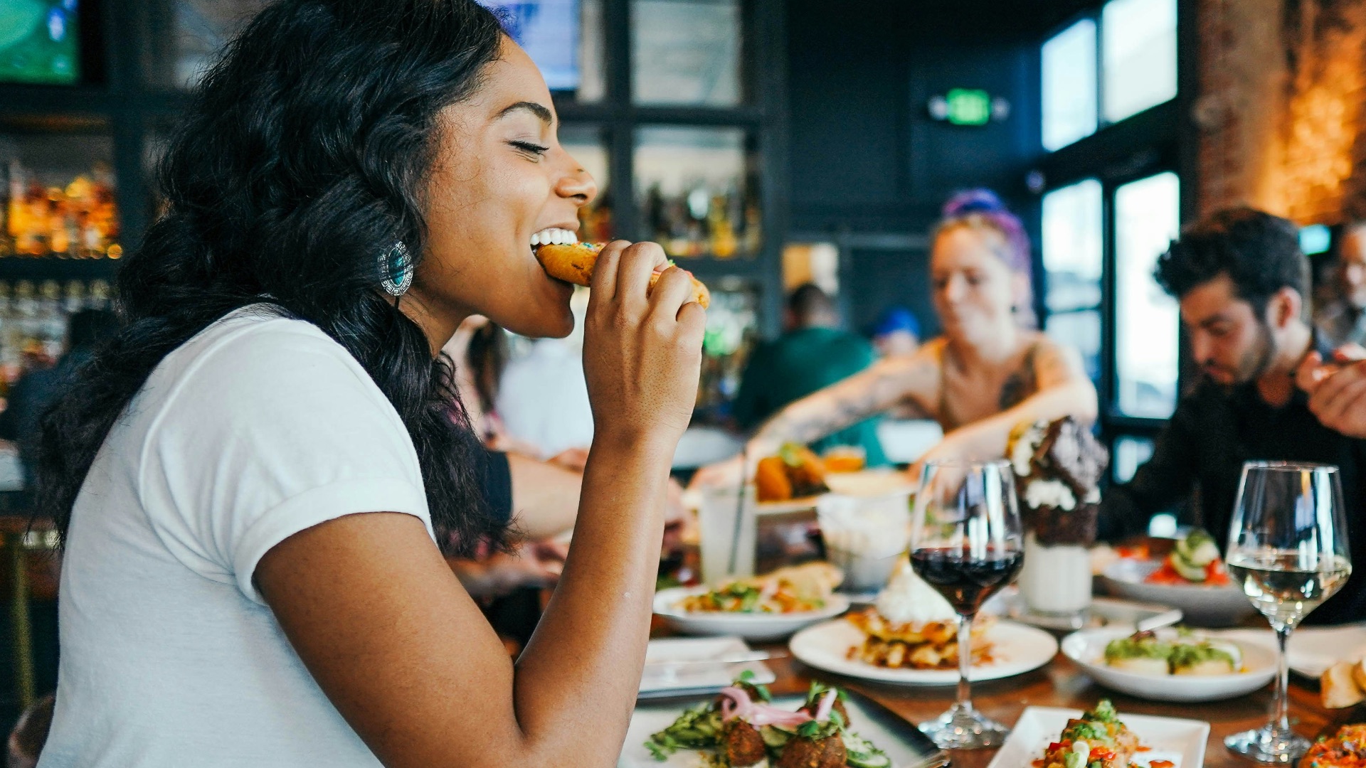 woman in white shirt eating