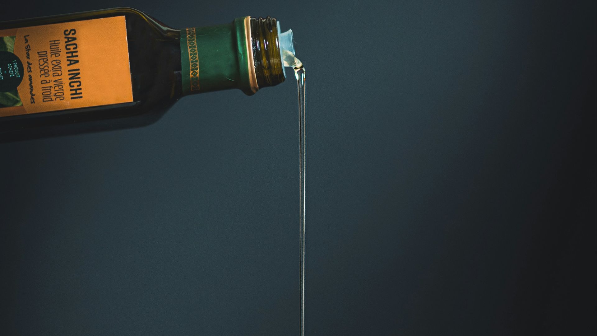 bottle with white liquid pouring through the brown slab