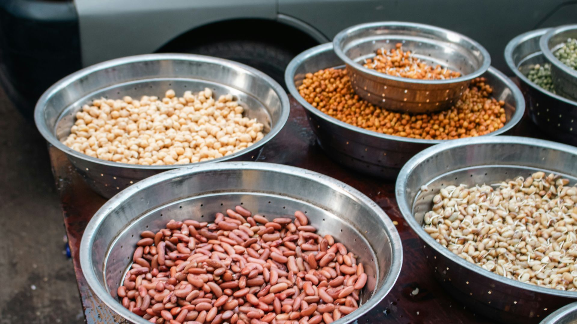 Bowls of assorted dried beans and legumes.