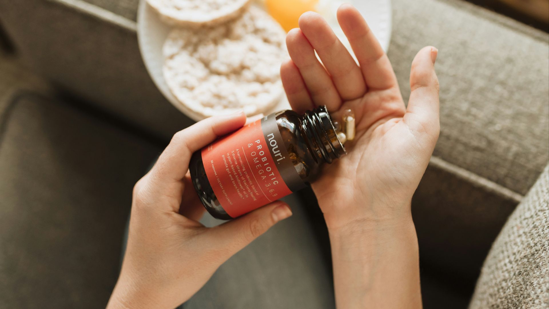 person holding red bottle