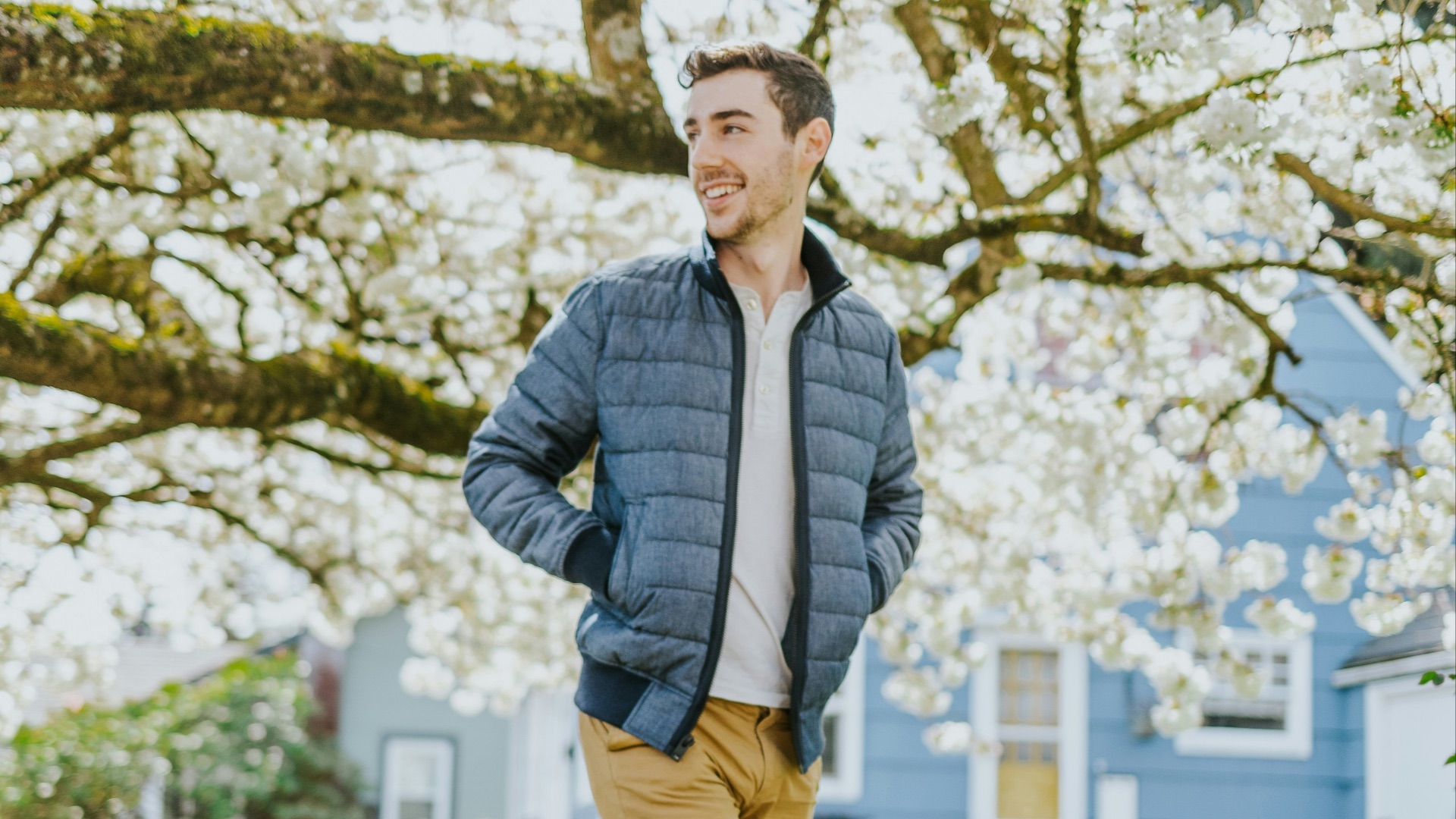 man in blue jacket standing on pathway during daytime