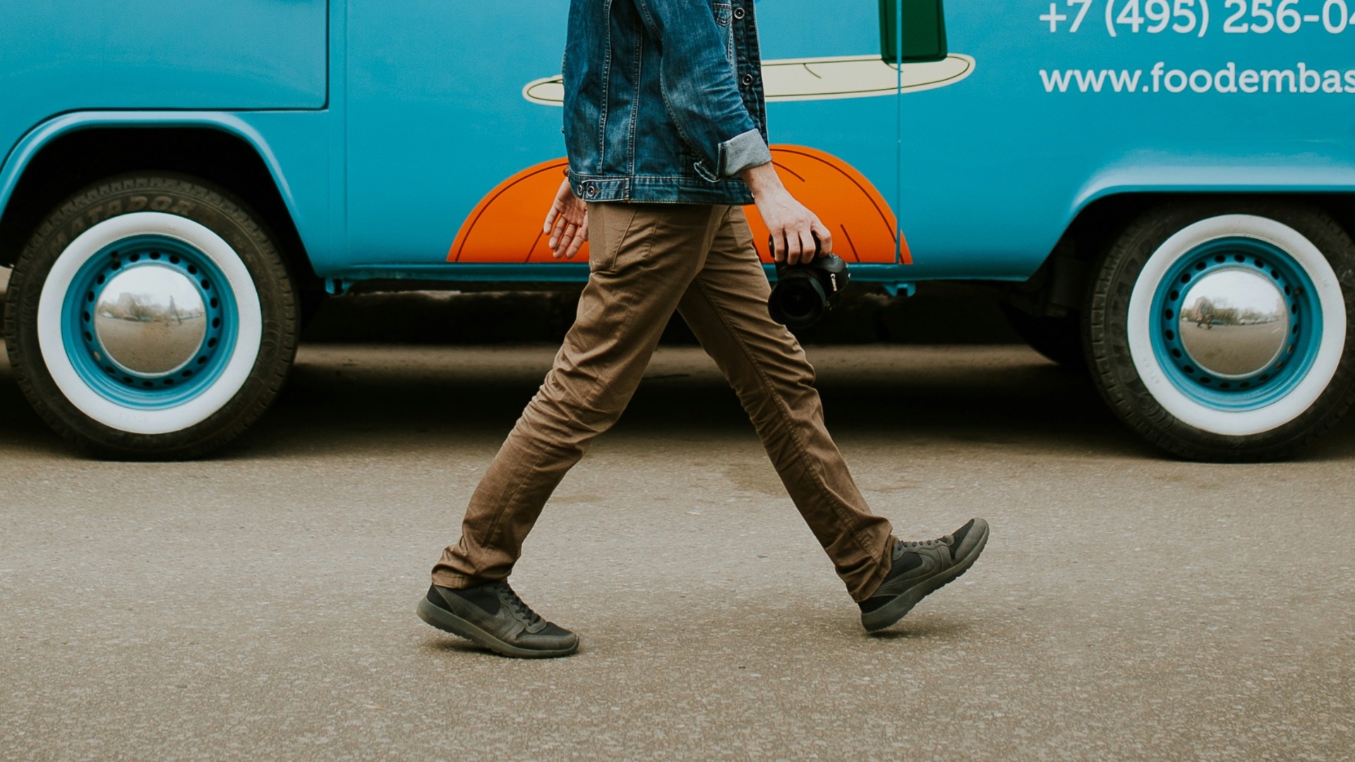 man walking beside van near concrete house