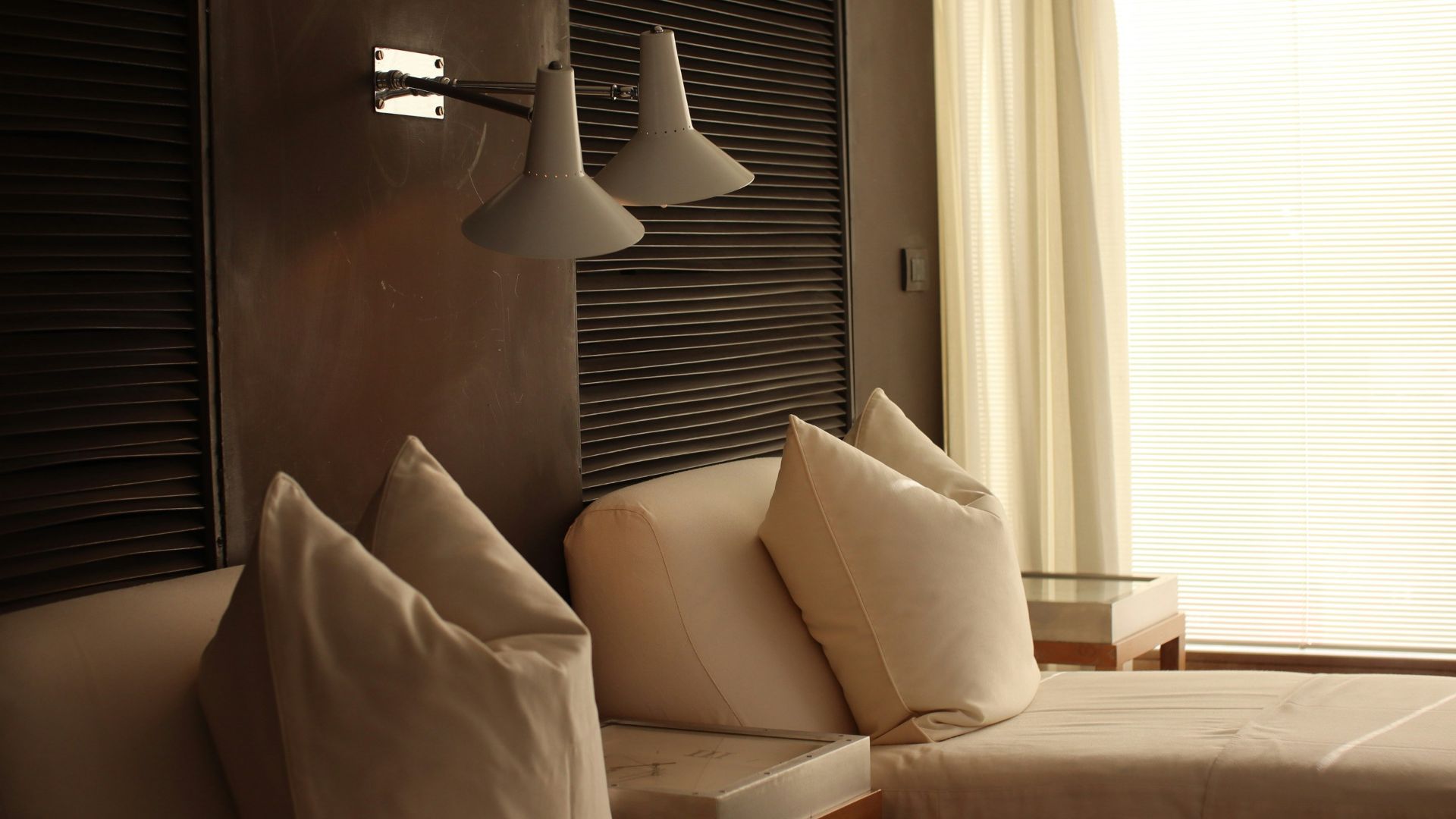 a bed room with a neatly made bed next to a window