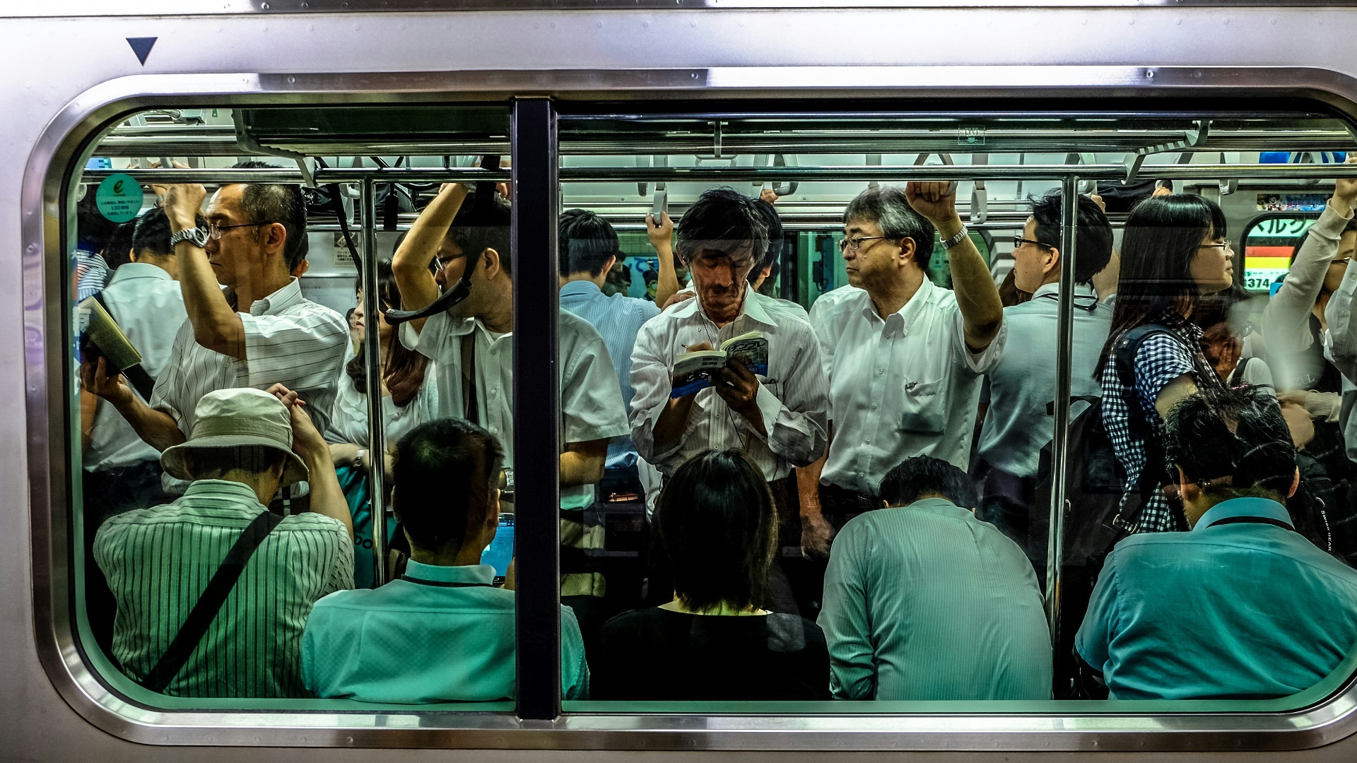 people sitting and standing inside train