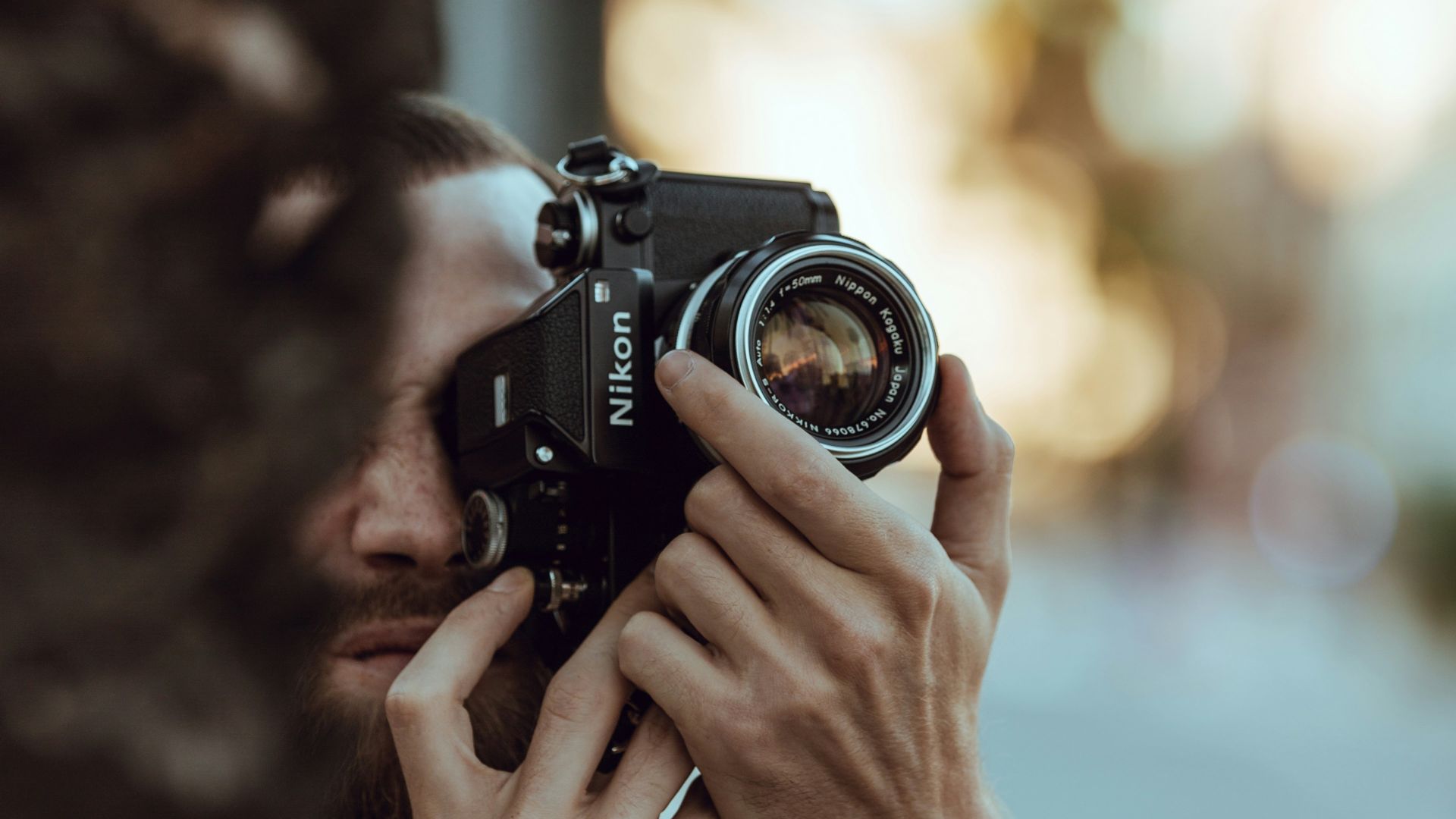 person using black Nikon DSLR camera