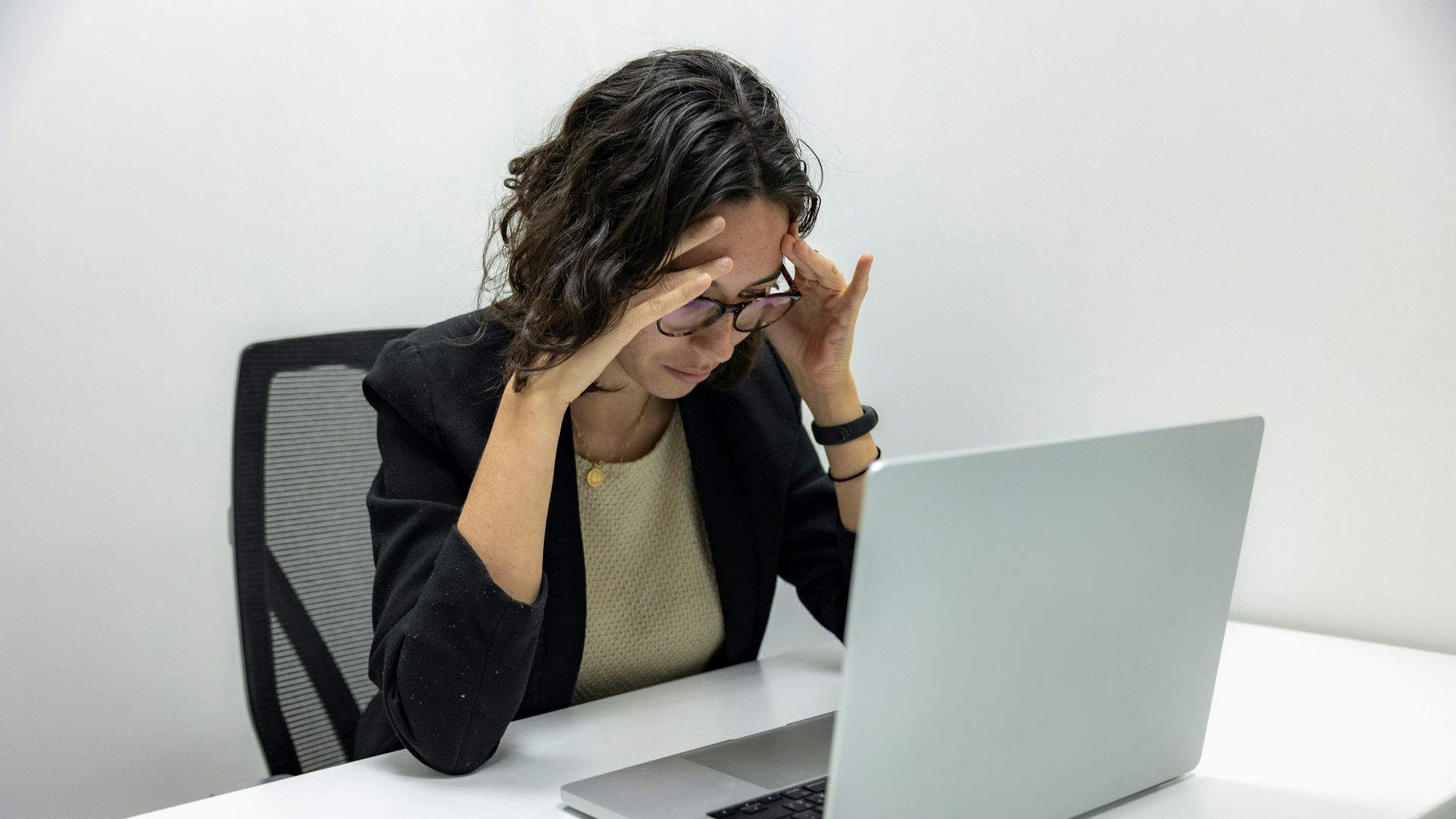 a woman sitting in front of a laptop computer