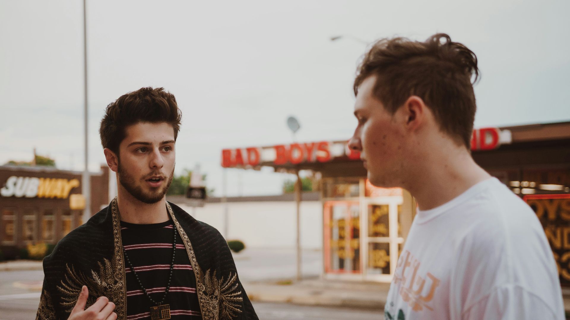 man talking to another man