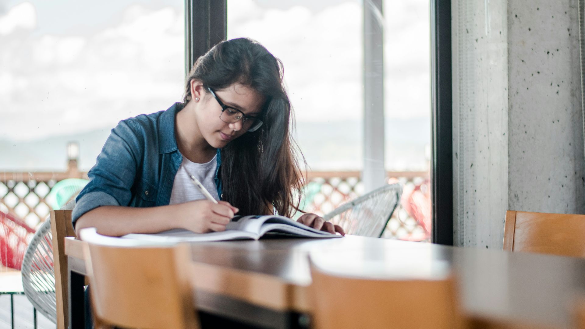 woman writing on book