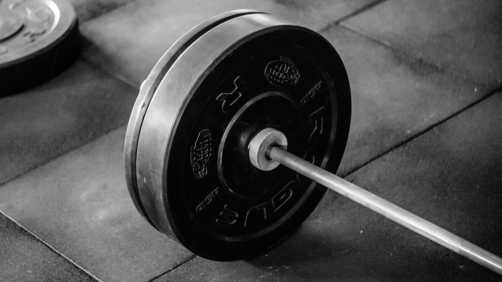 black barbell on tile flooring