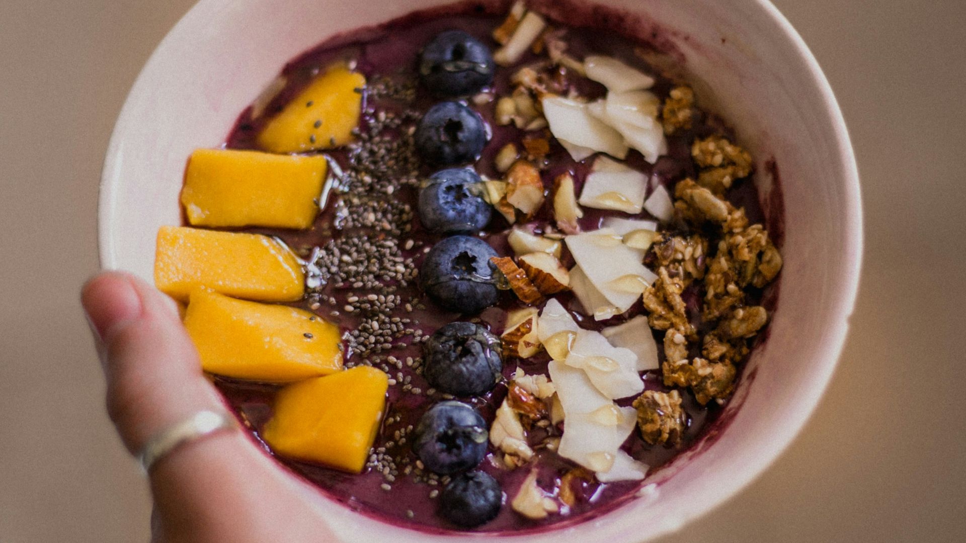 person holding bowl with food