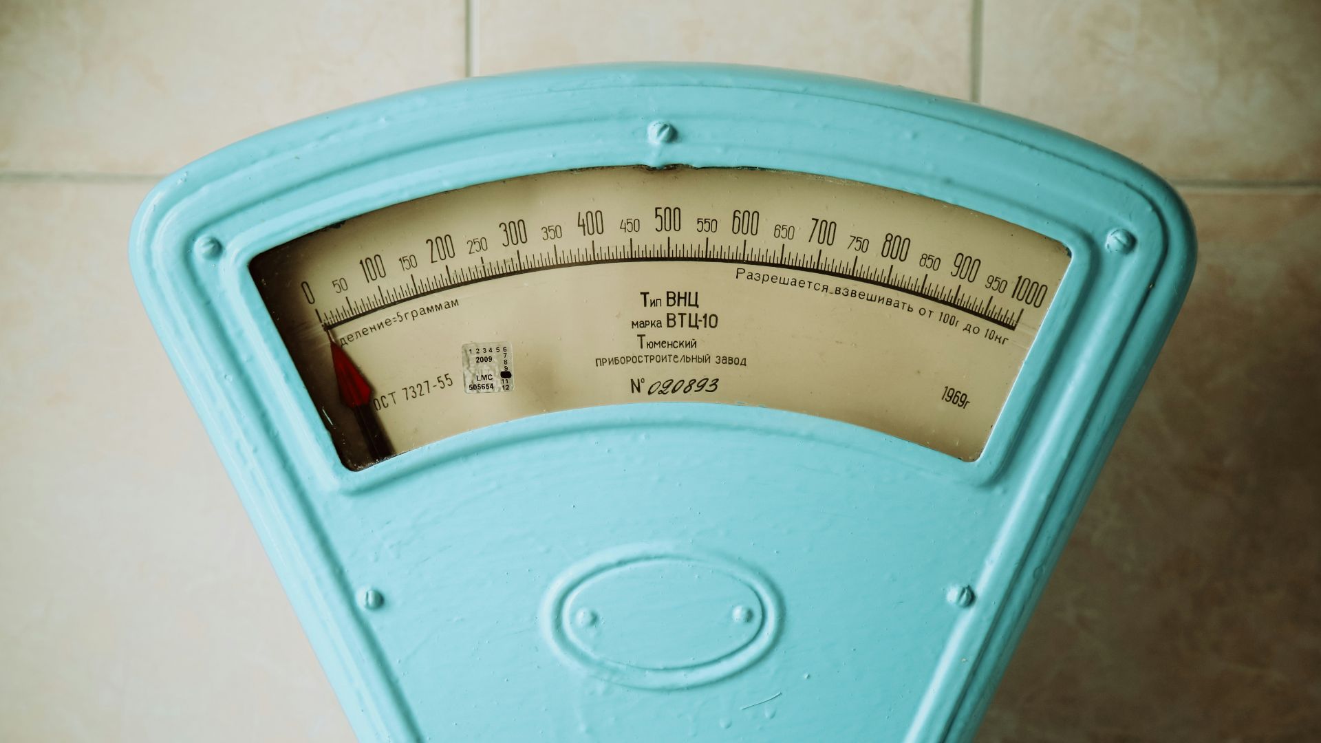 a close up of a meter on a tiled wall