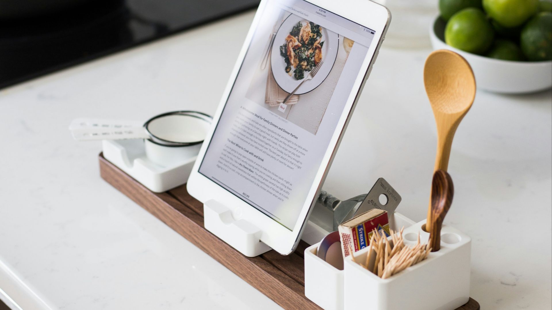 closeup photo of turned on iPad with rack on table