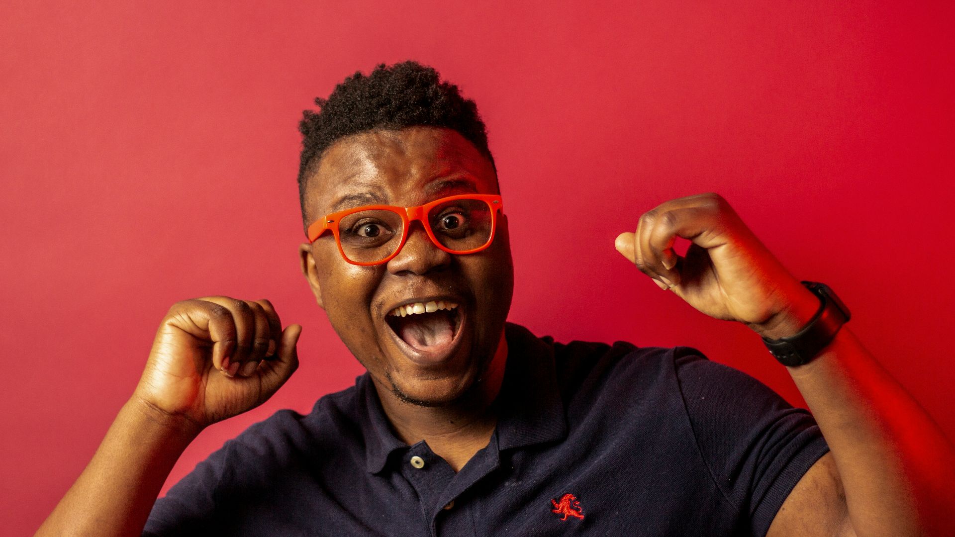 man in black polo shirt wearing black framed eyeglasses