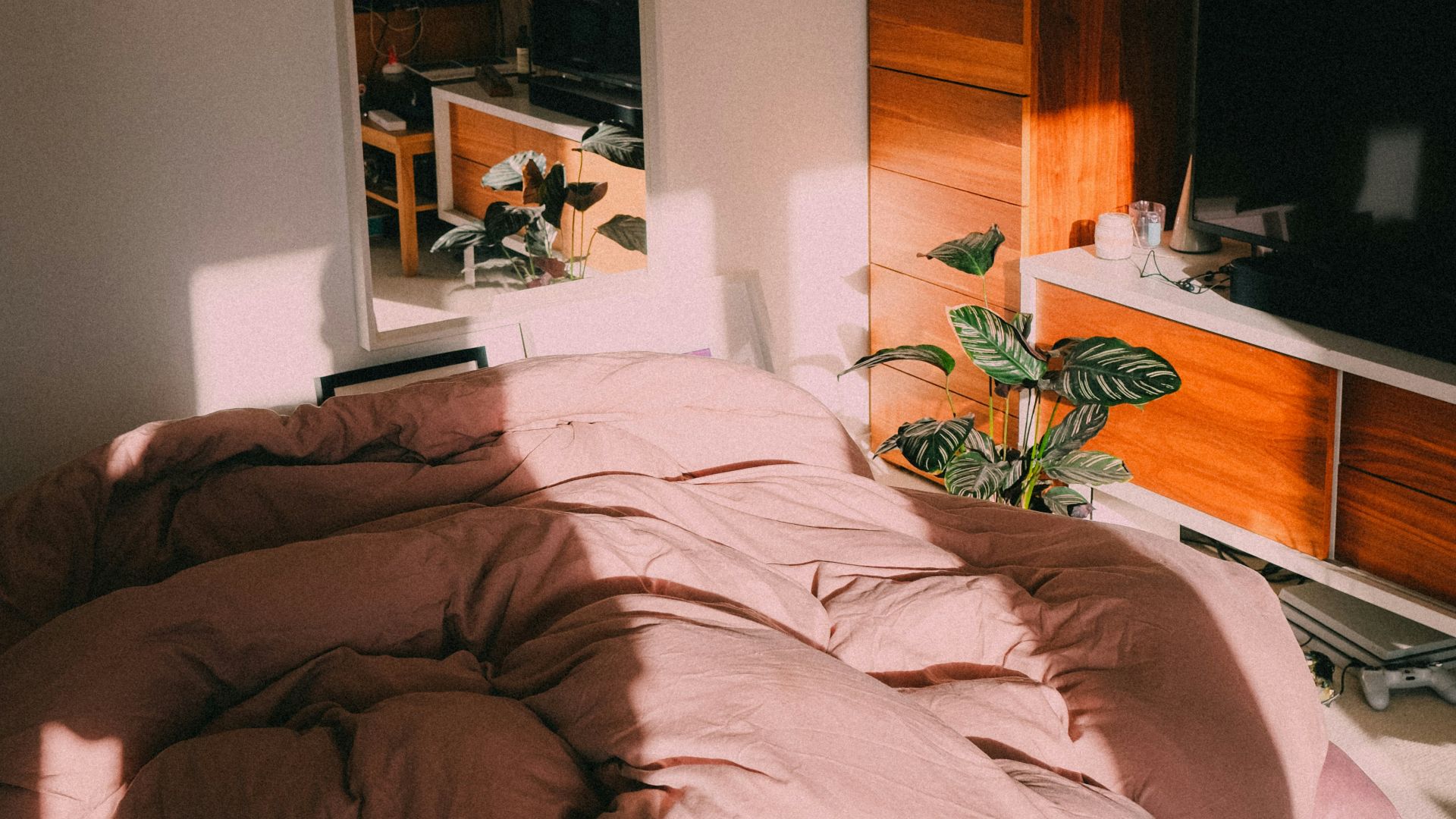black flat screen tv on brown wooden tv rack