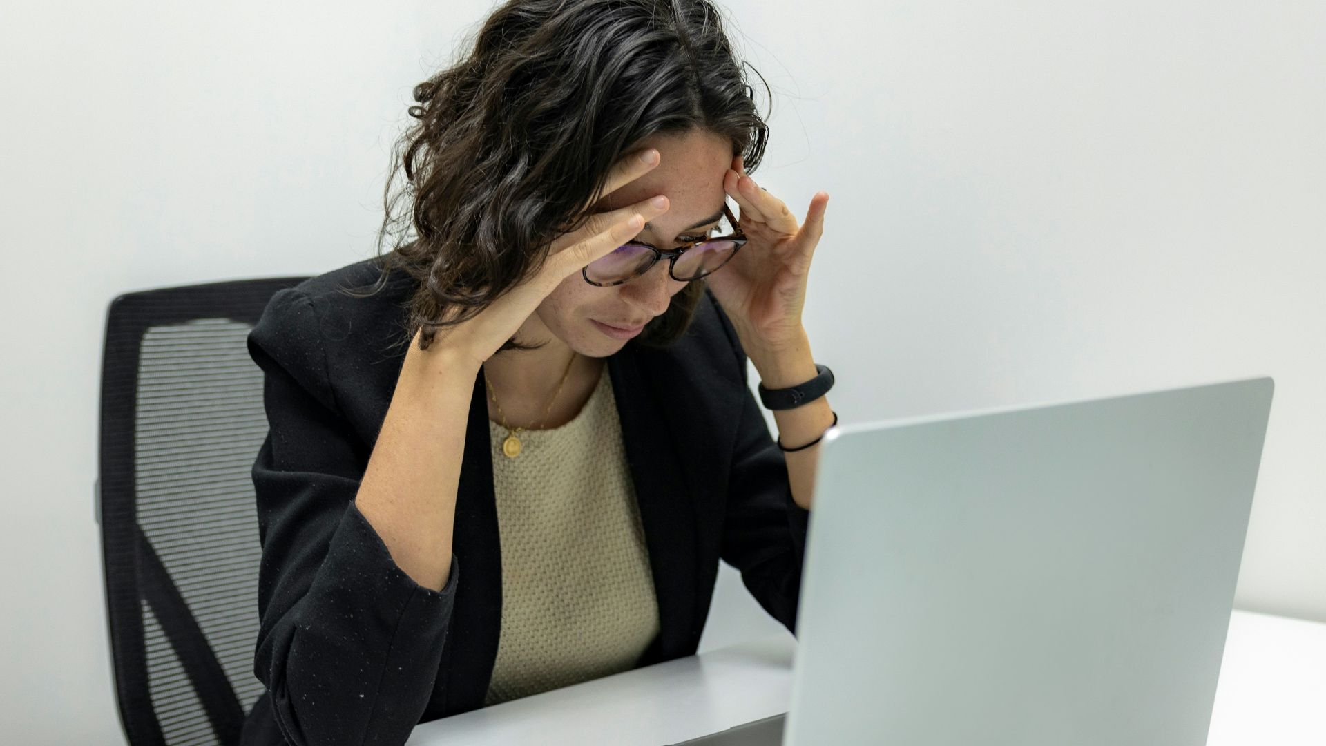 a woman sitting in front of a laptop computer