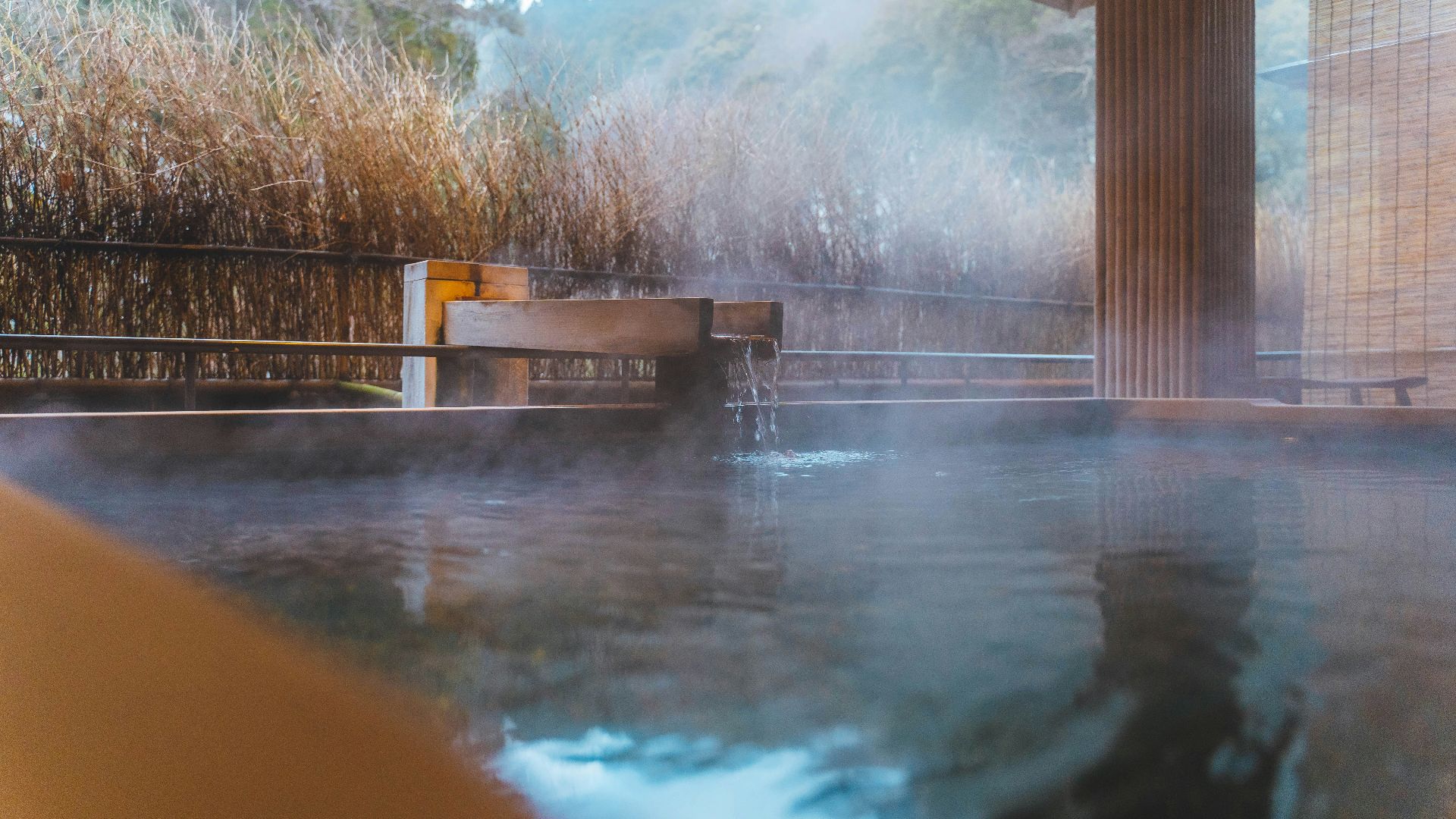 a large pool of water next to a tall building