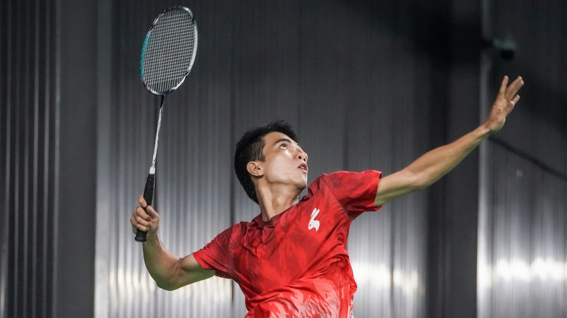A man jumping in the air with a tennis racket