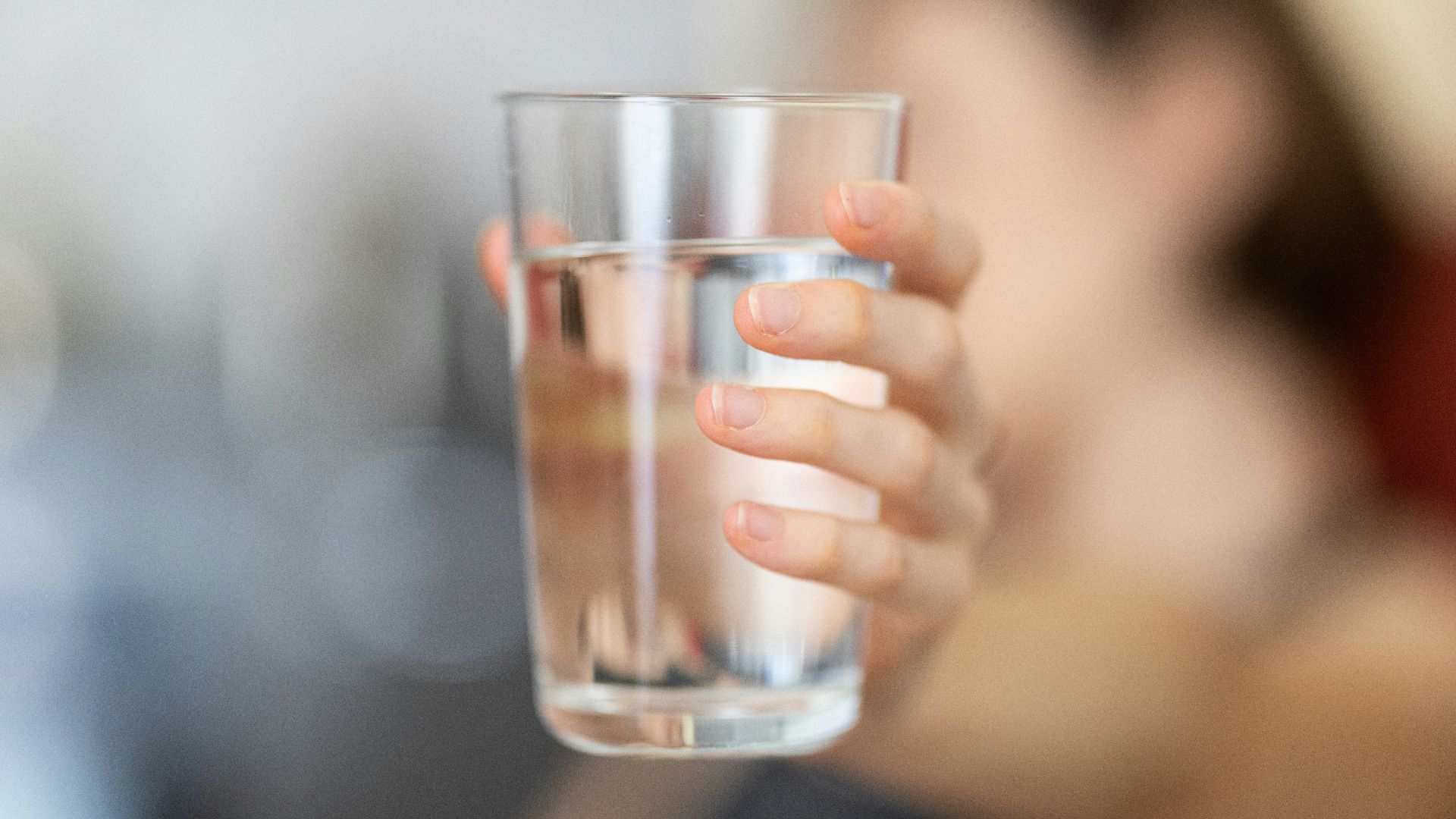 person holding clear drinking glass