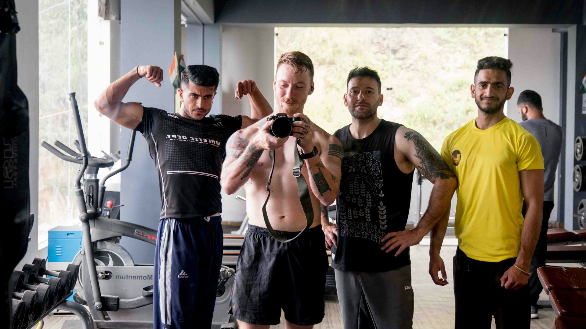 a group of men standing next to each other in a gym