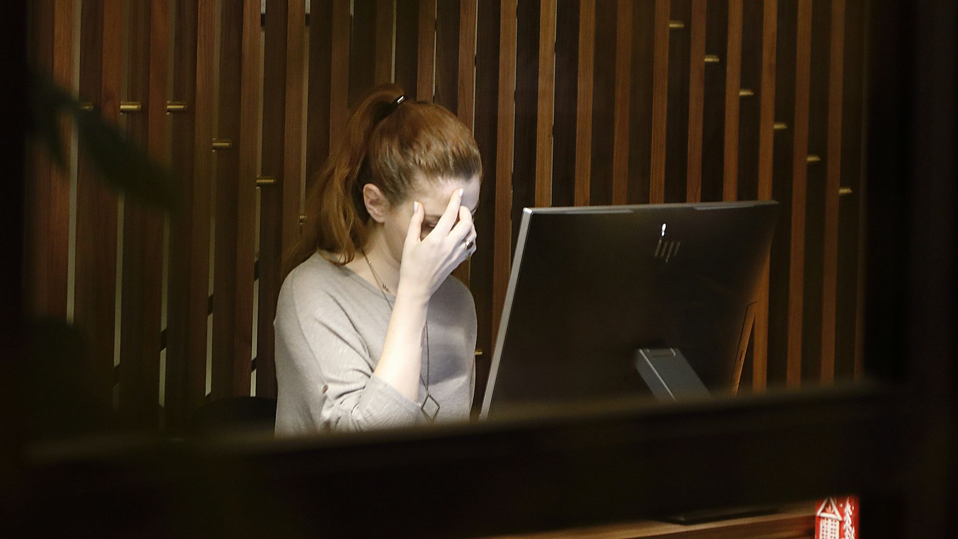 a woman sitting in front of a laptop computer