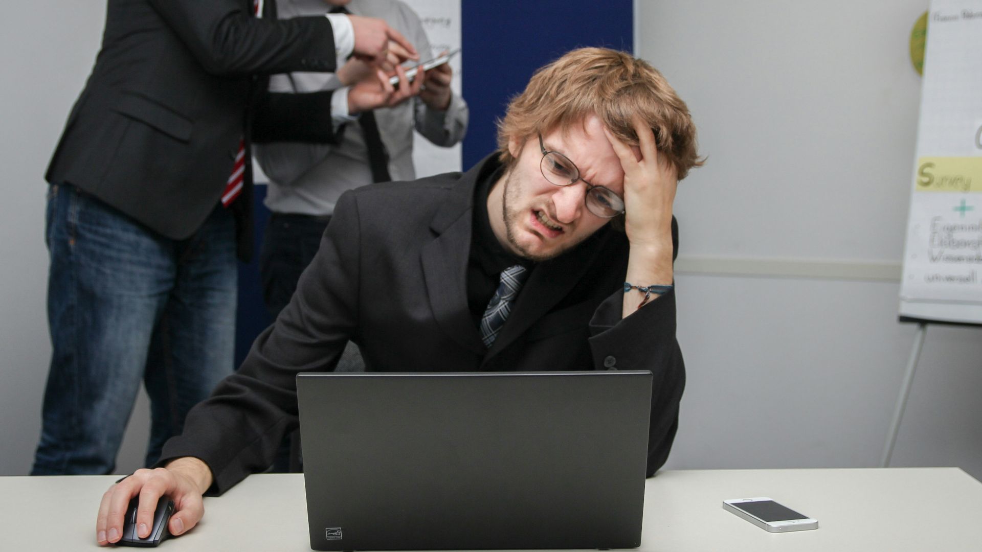 A man sitting in front of a laptop computer
