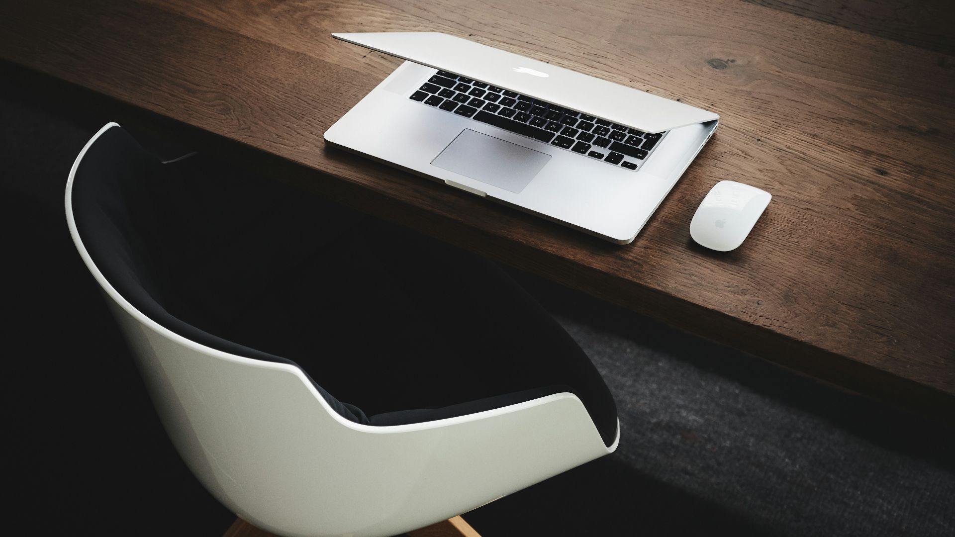 Apple MacBook beside computer mouse on table