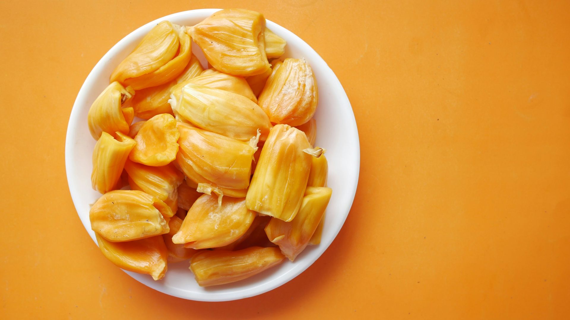 sliced yellow fruit in white ceramic bowl