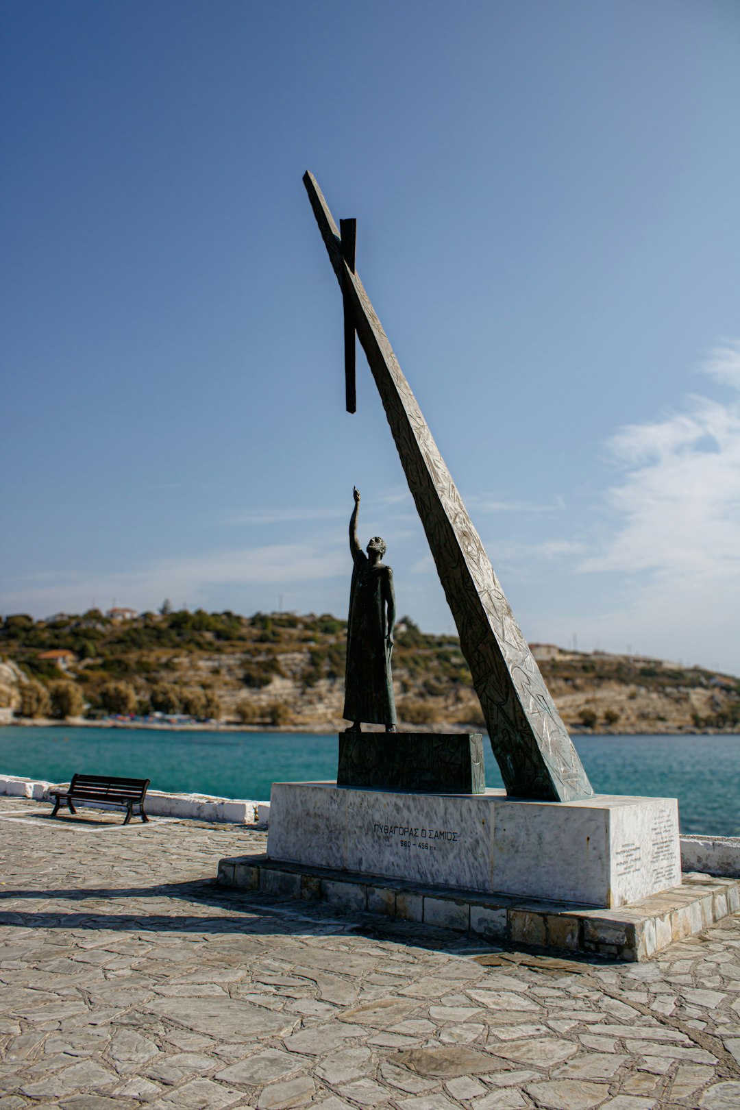 a statue of a person holding a cross