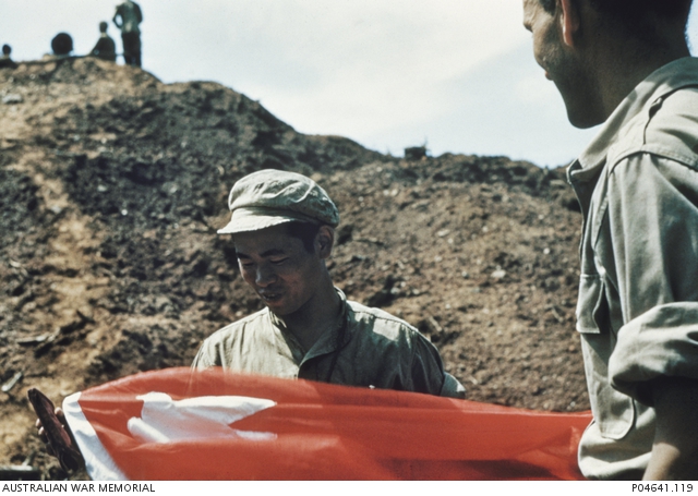 File:PVA officer presents red peace flag to Australian correspondent after the ceasefire.jpg