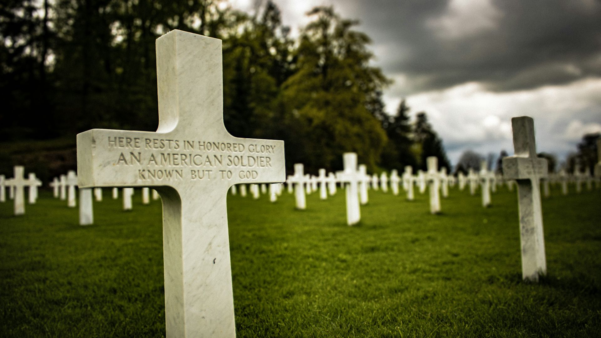 a cemetery with many headstones and crosses