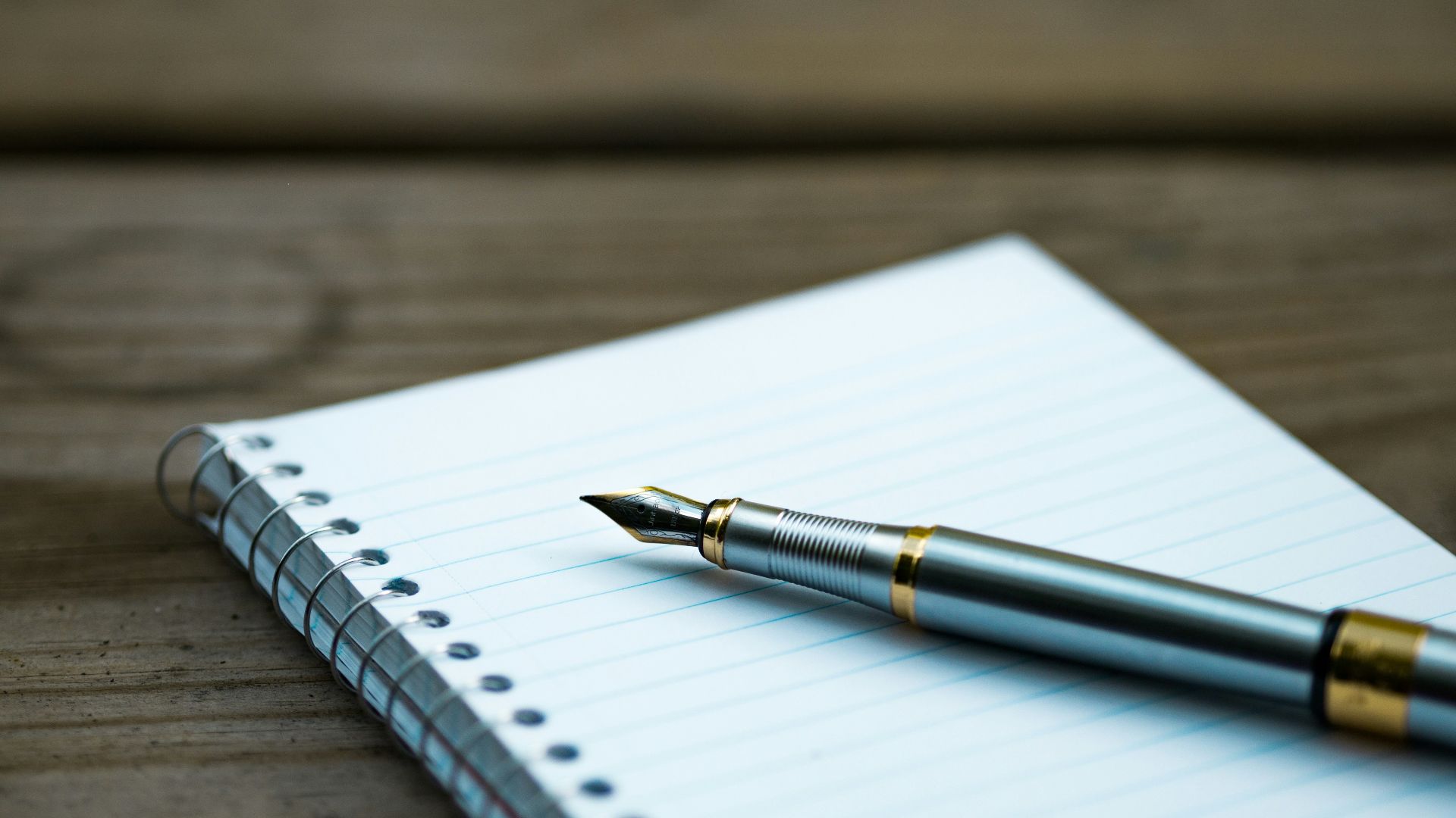 fountain pen on spiral book